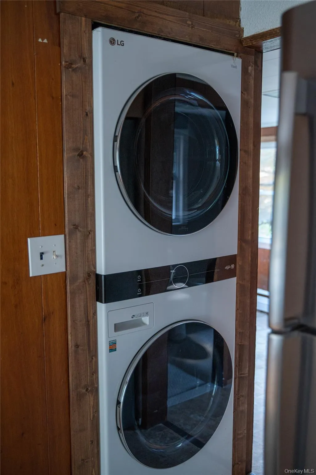 Laundry area featuring stacked washer / dryer Laundry area featuring stacked washer / dryer