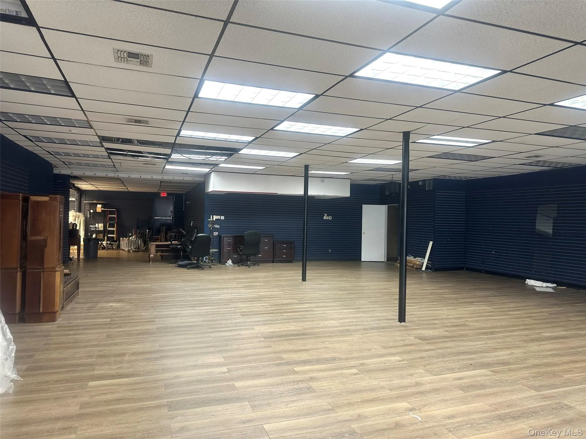 Basement featuring a drop ceiling and light wood-type flooring Basement featuring a drop ceiling and light wood-type flooring