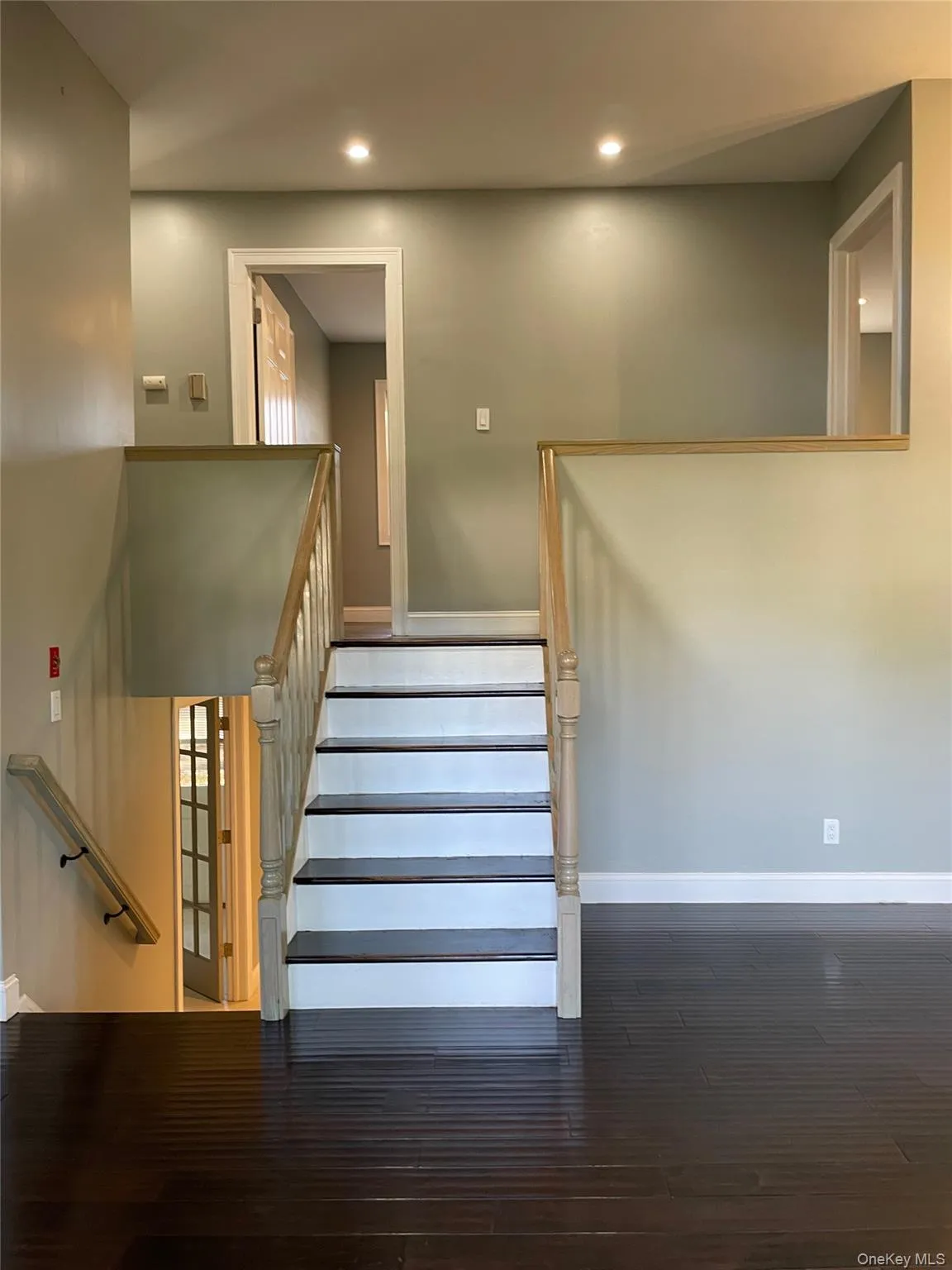 Staircase with wood finished floors and recessed lighting Staircase with wood finished floors and recessed lighting