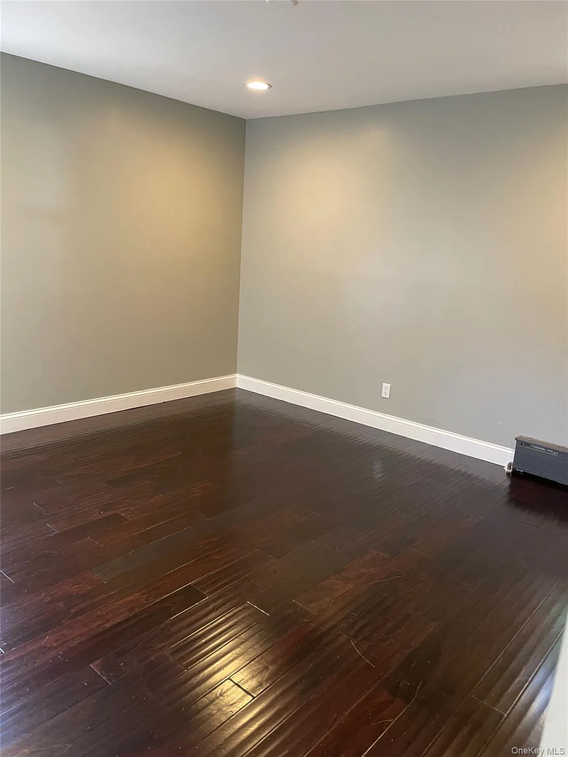 Spare room with dark wood finished floors and recessed lighting Spare room with dark wood finished floors and recessed lighting