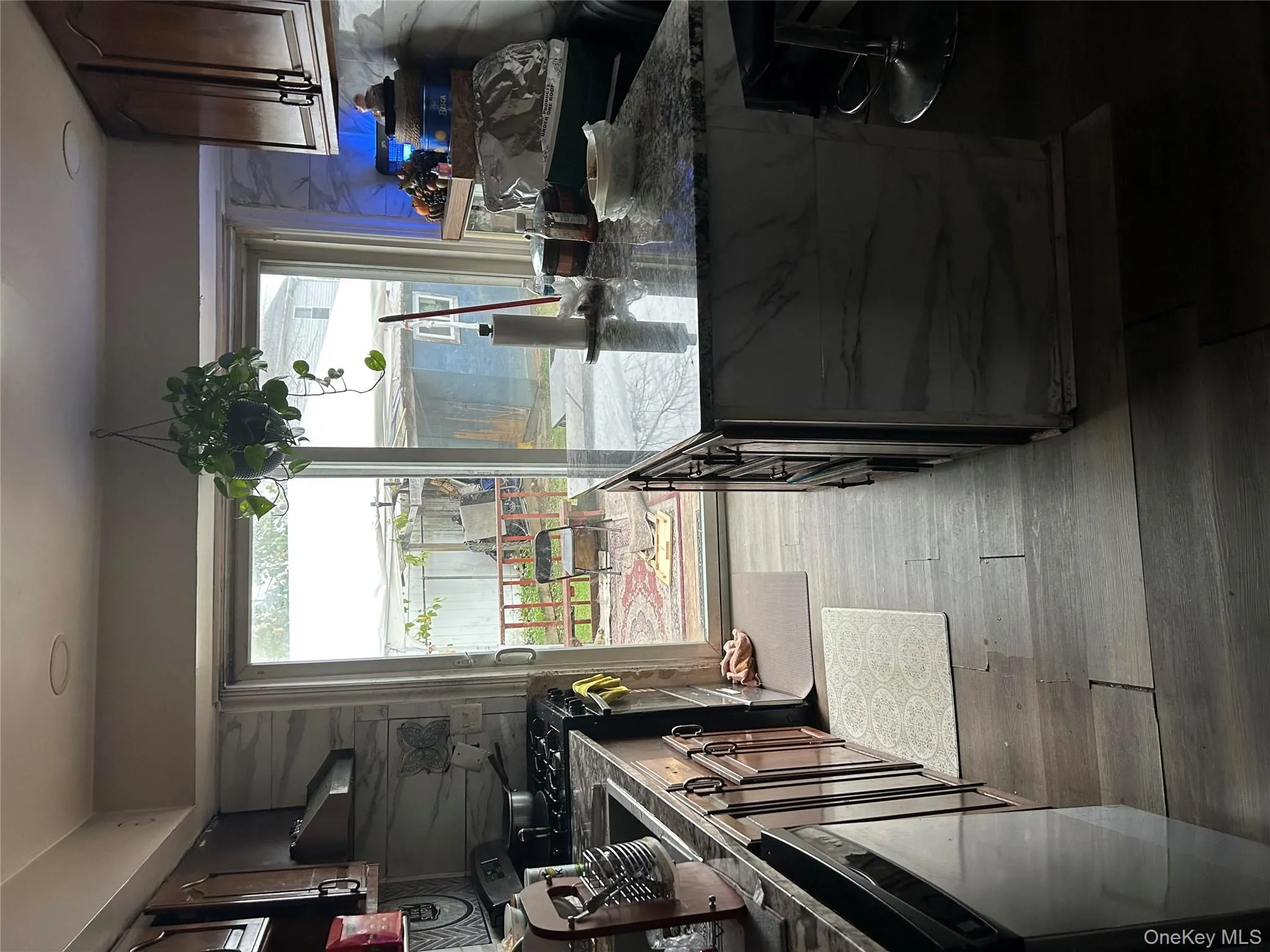 Kitchen featuring range, dark stone countertops, healthy amount of natural light, and dishwashing machine Kitchen featuring range, dark stone countertops, healthy amount of natural light, and dishwashing machine