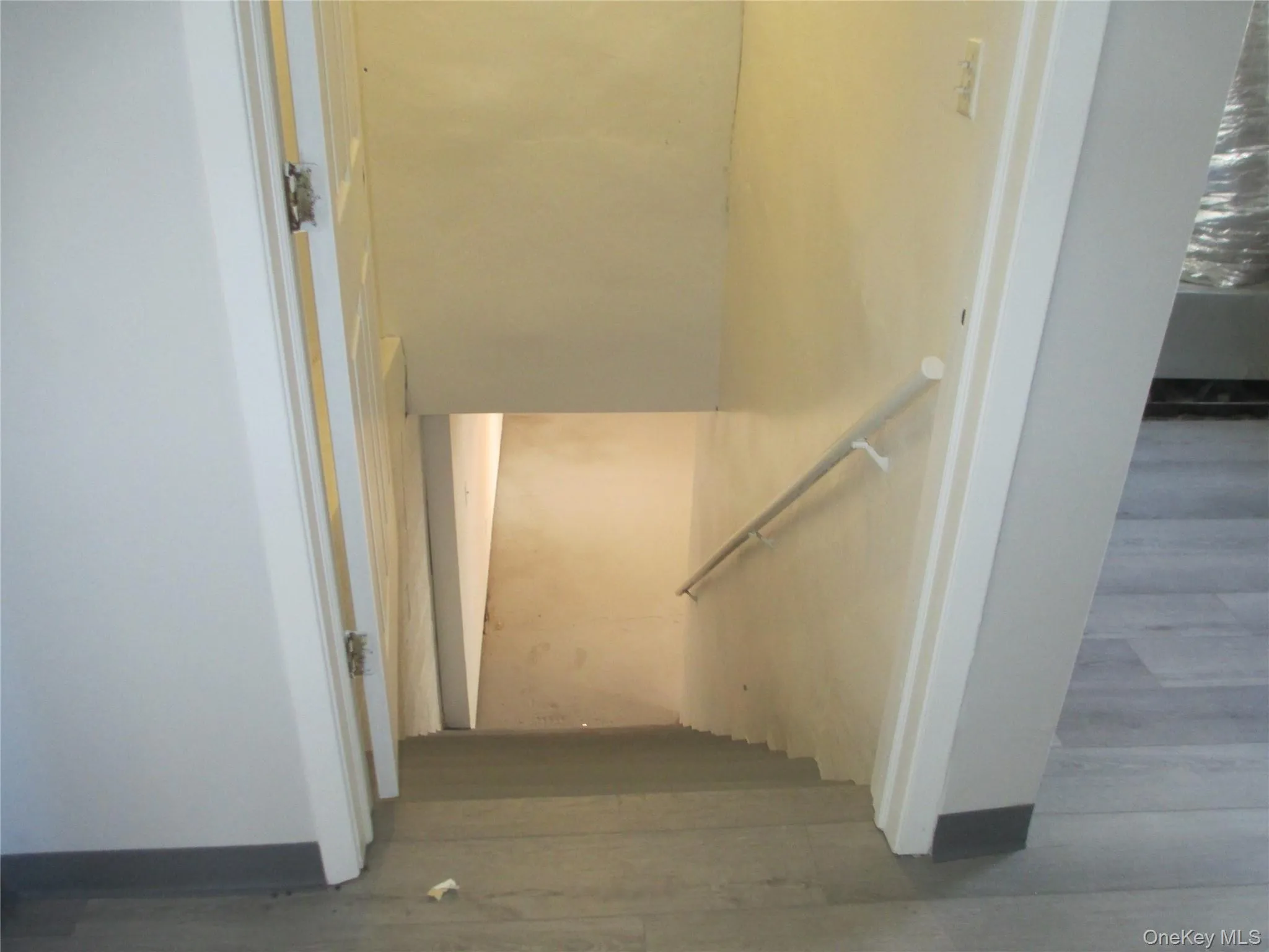 Stairs featuring wood finished floors Stairs featuring wood finished floors