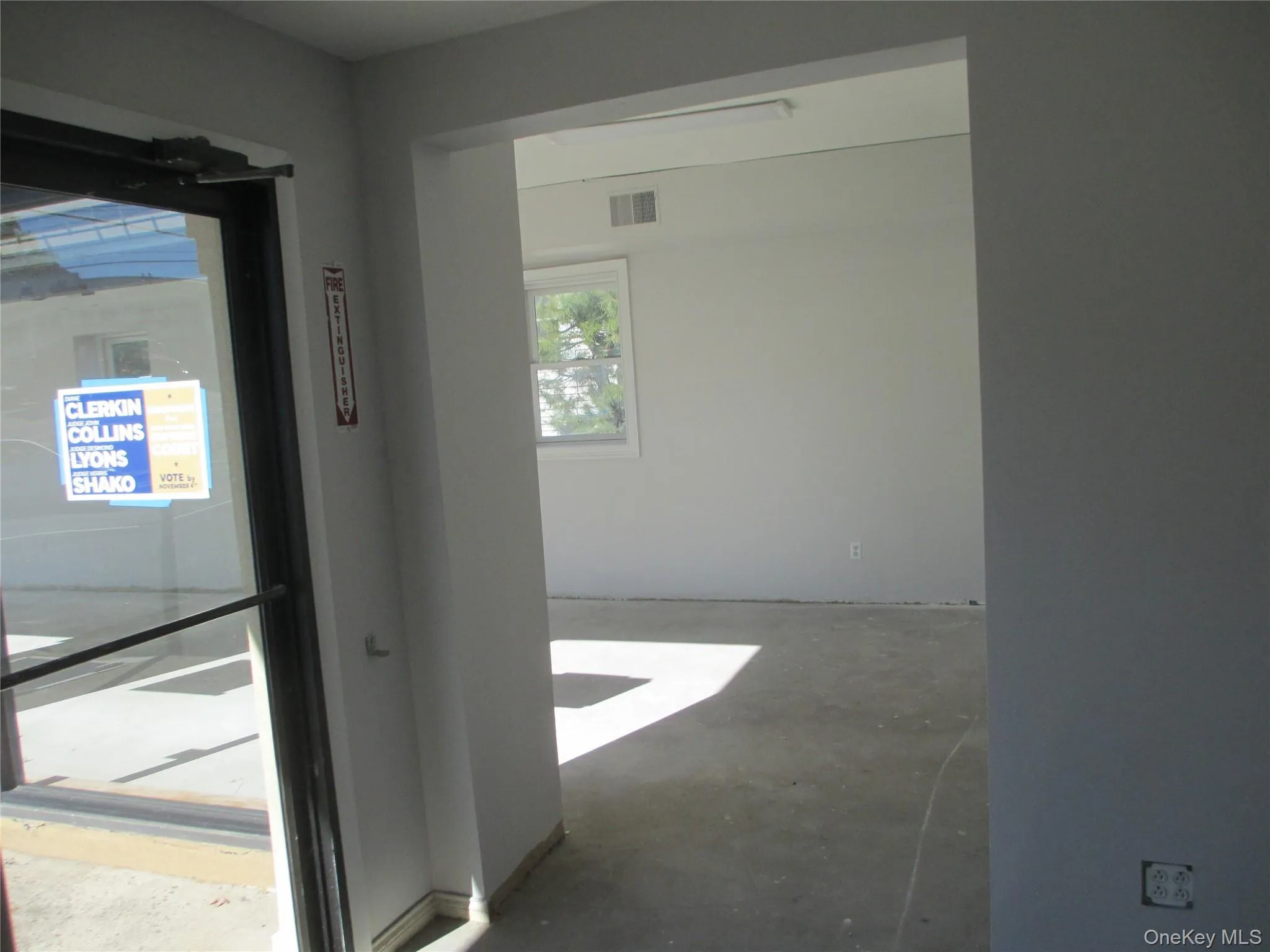 Corridor featuring unfinished concrete floors Corridor featuring unfinished concrete floors