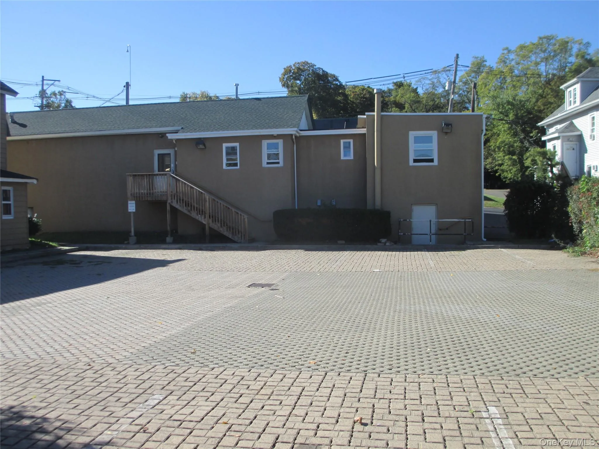 Back of property featuring stucco siding Back of property featuring stucco siding