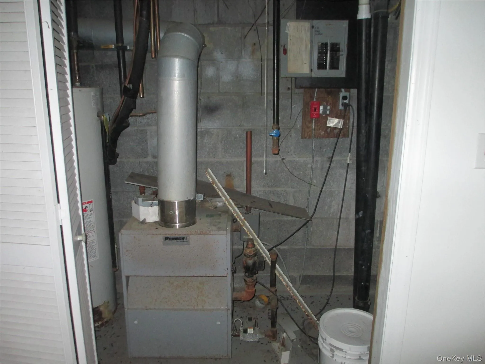 Utility room featuring gas water heater, electric panel, and a heating unit Utility room featuring gas water heater, electric panel, and a heating unit