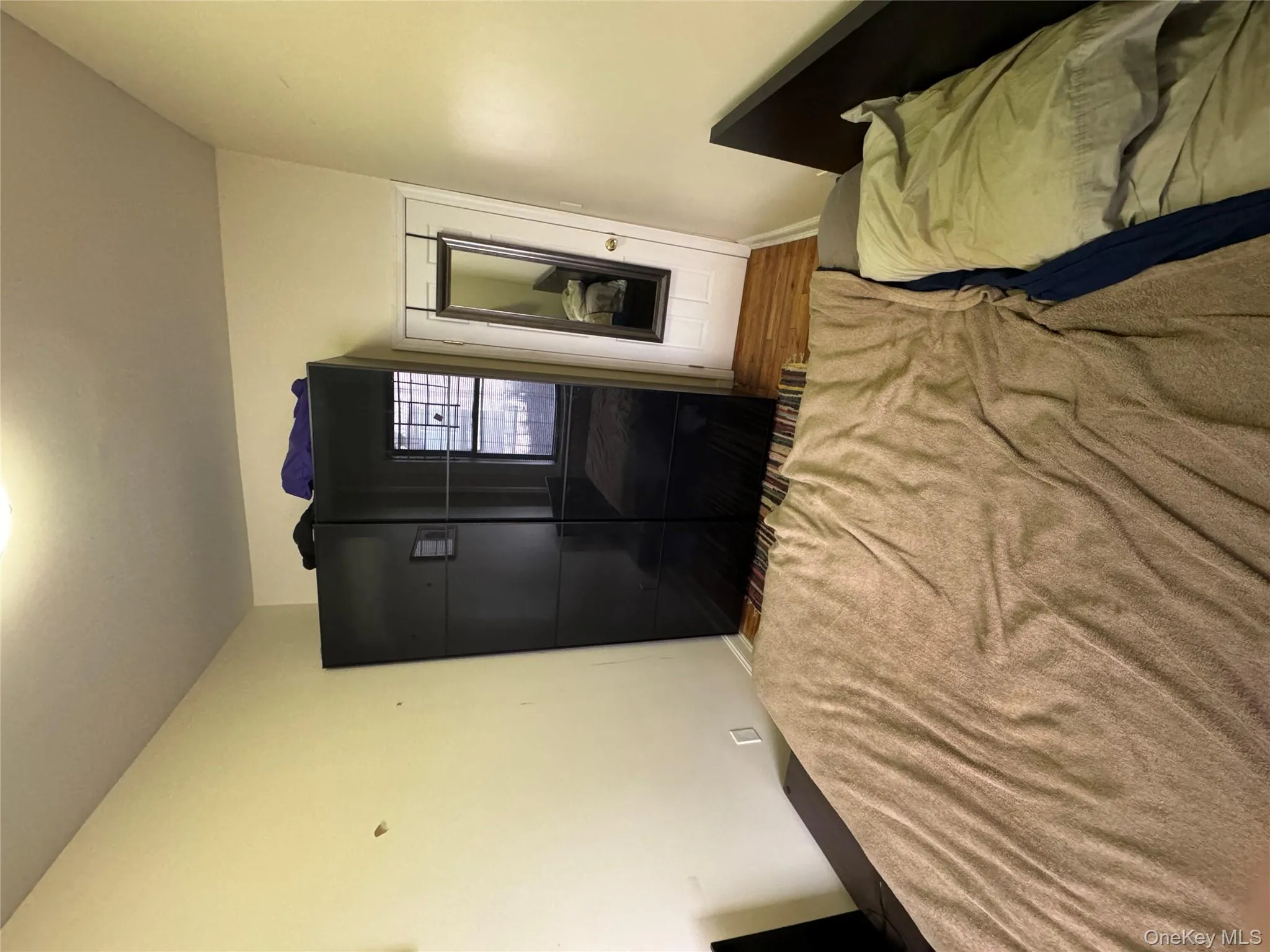 Bedroom with wood finished floors and baseboards Bedroom with wood finished floors and baseboards