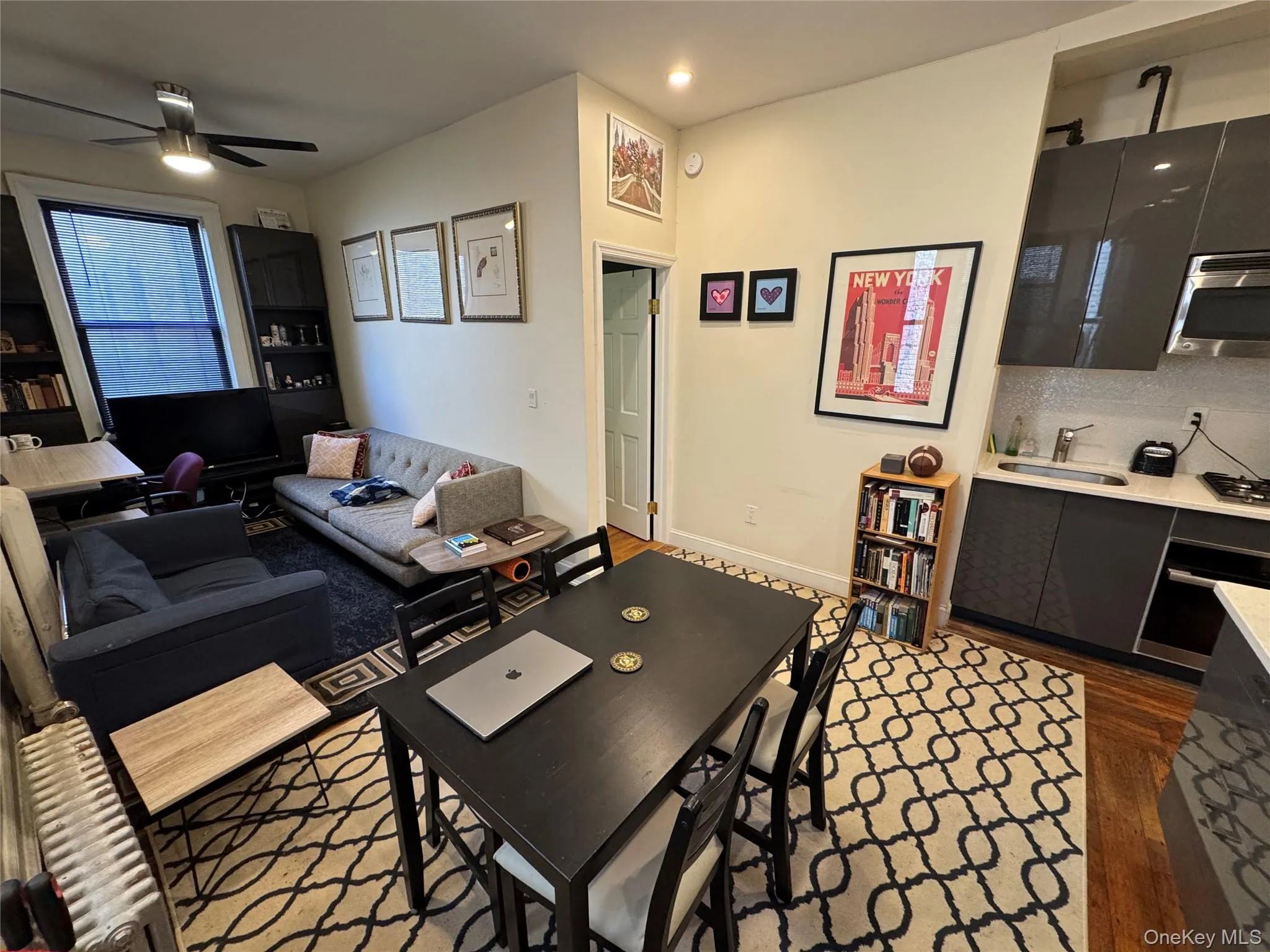 Living room featuring dark wood-style flooring, a ceiling fan, and recessed lighting Living room featuring dark wood-style flooring, a ceiling fan, and recessed lighting