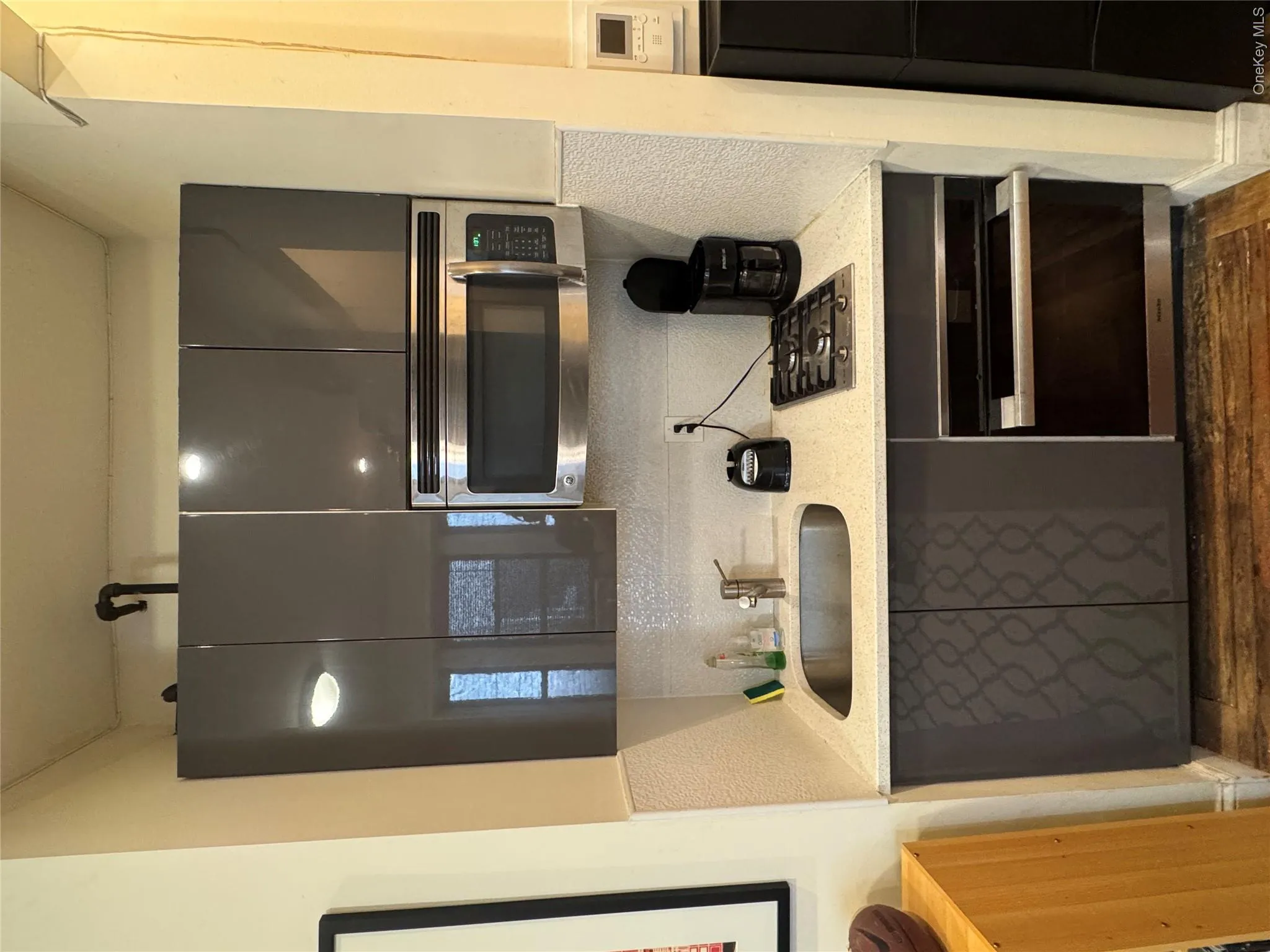 Bathroom with decorative backsplash, dark wood-style flooring, and vanity Bathroom with decorative backsplash, dark wood-style flooring, and vanity