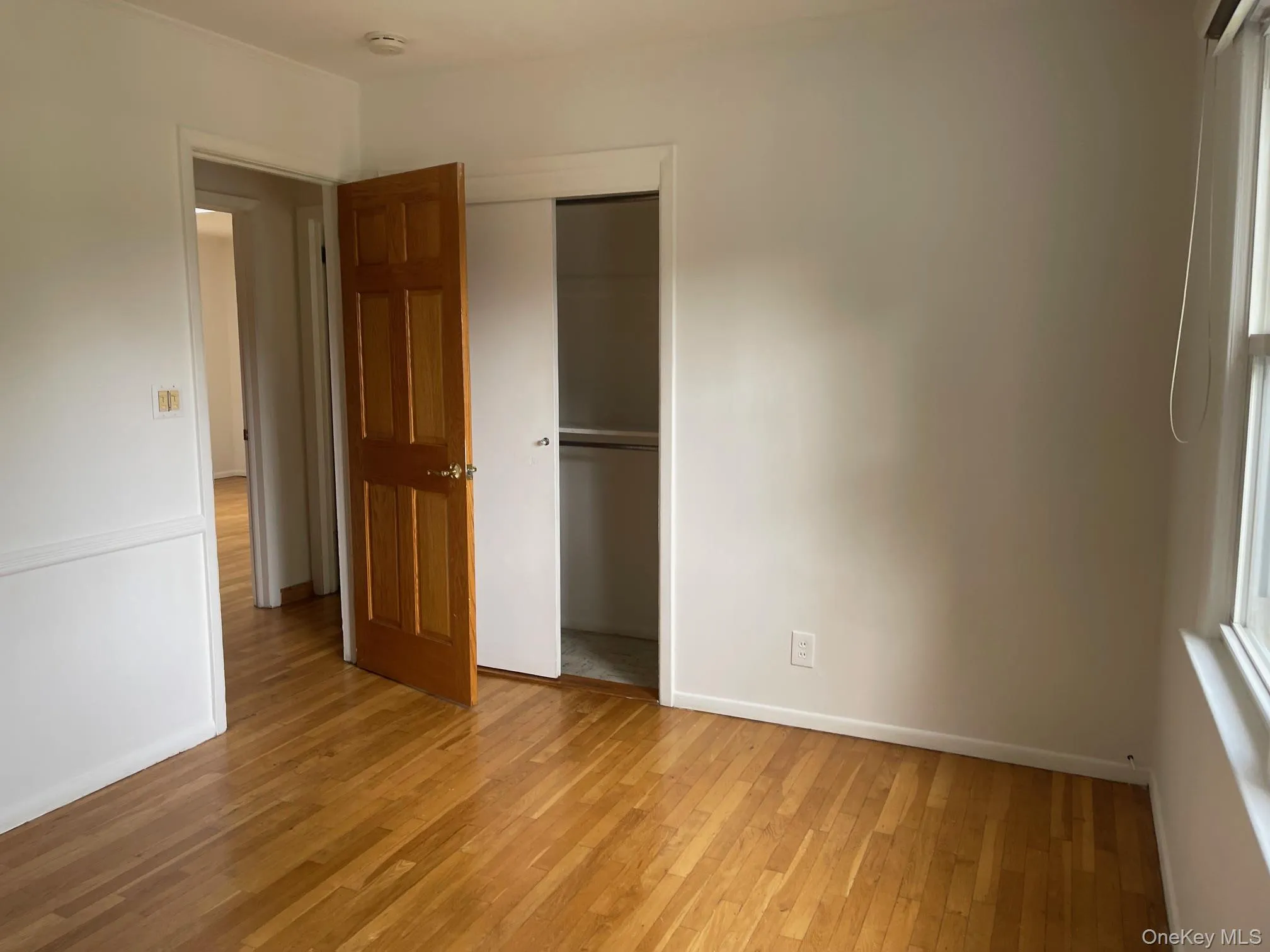 Unfurnished bedroom featuring light wood-type flooring and a closet Unfurnished bedroom featuring light wood-type flooring and a closet