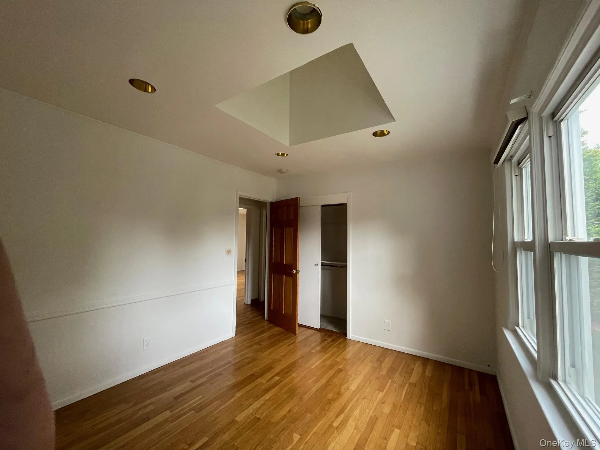 Unfurnished bedroom with a closet, light wood-style flooring, and recessed lighting Unfurnished bedroom with a closet, light wood-style flooring, and recessed lighting