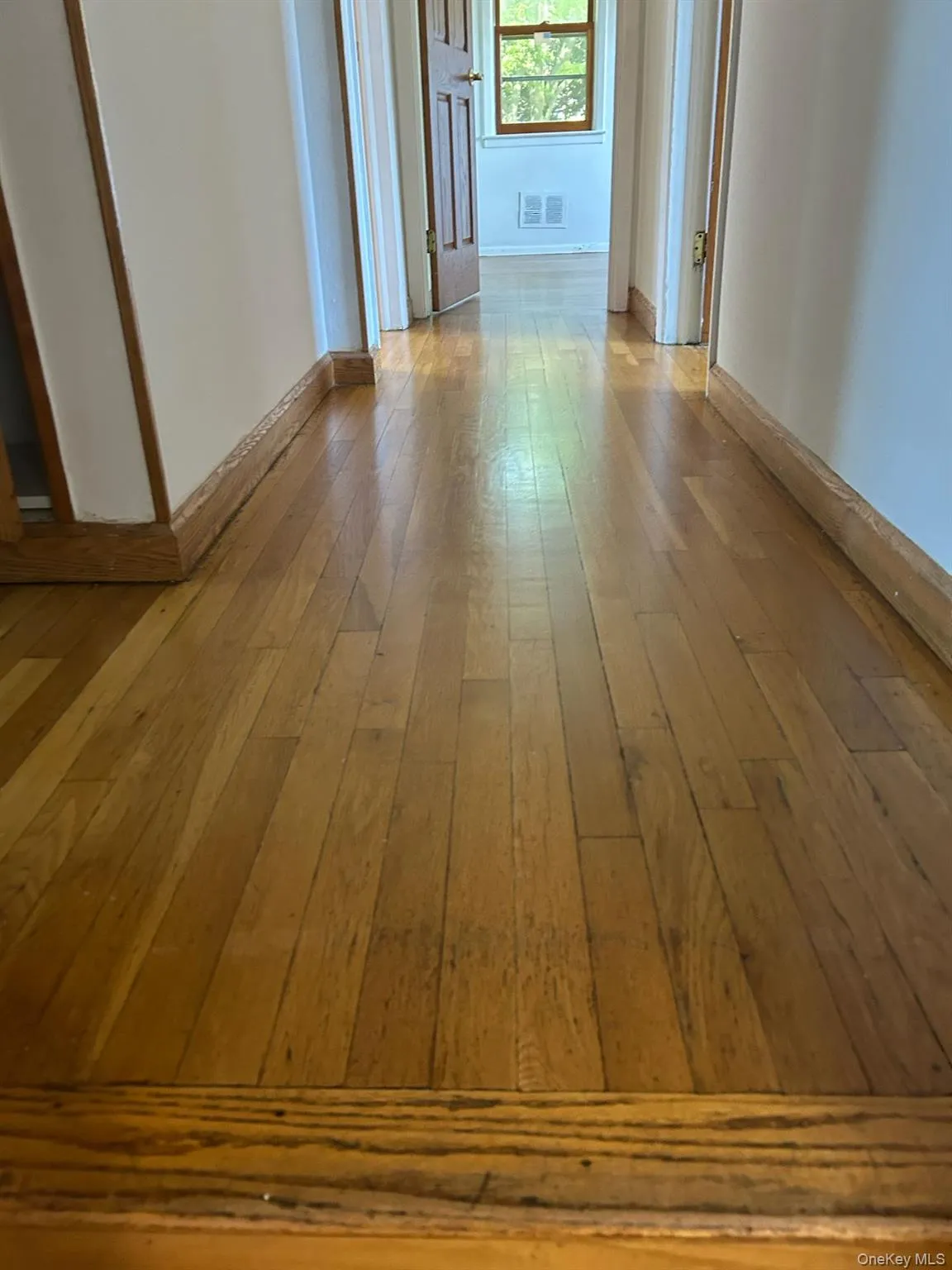 Hallway featuring light wood finished floors Hallway featuring light wood finished floors