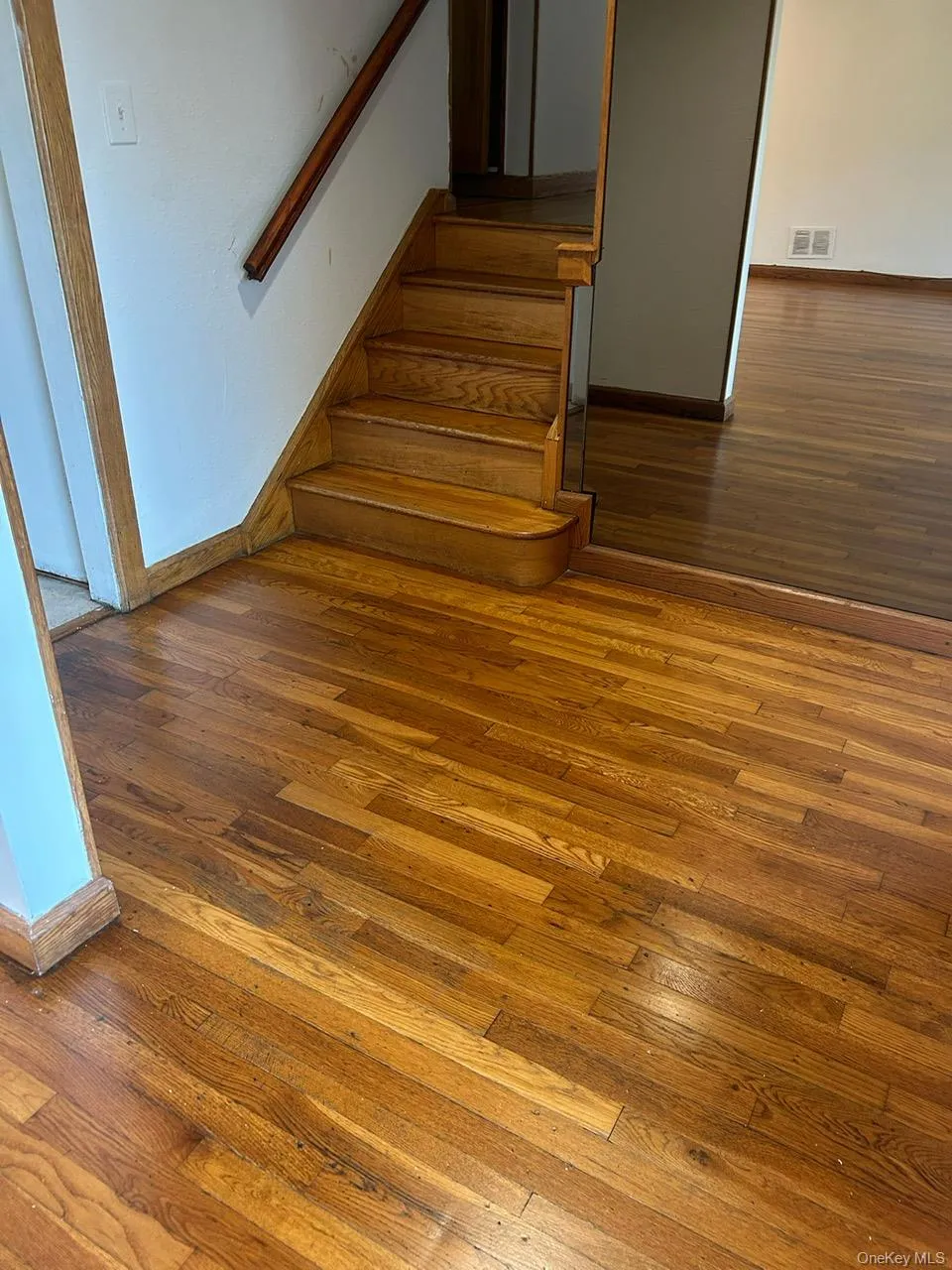 Stairway with hardwood / wood-style floors and baseboards Stairway with hardwood / wood-style floors and baseboards
