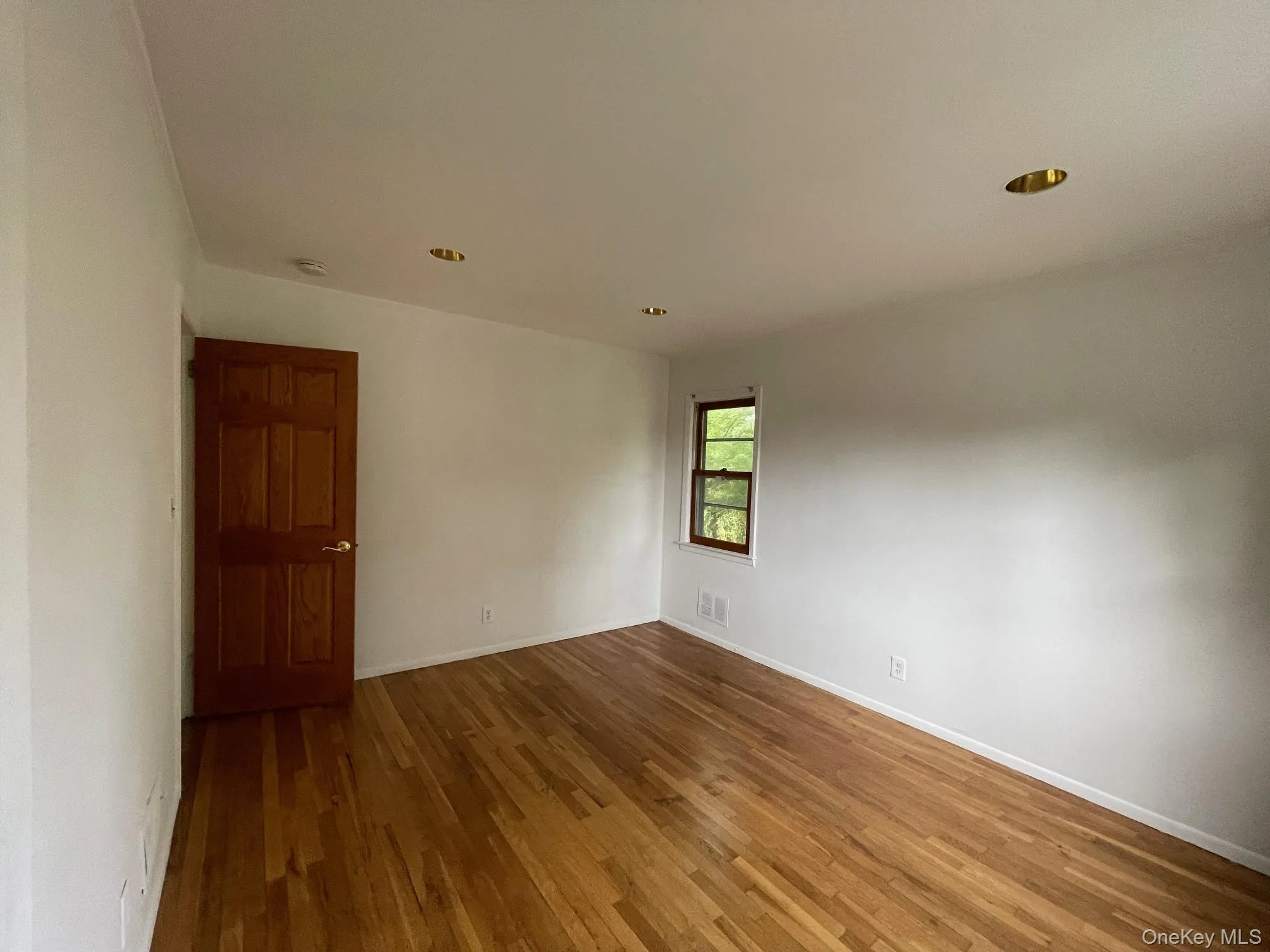 Empty room featuring hardwood / wood-style flooring and recessed lighting Empty room featuring hardwood / wood-style flooring and recessed lighting