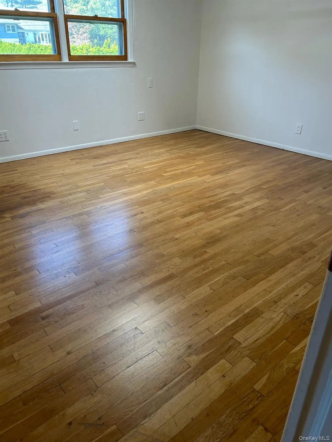 Empty room featuring light wood finished floors and baseboards Empty room featuring light wood finished floors and baseboards