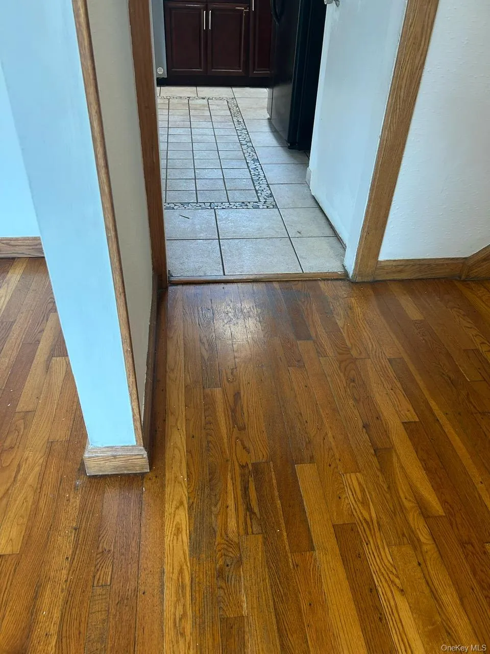 Hallway with light wood-type flooring and inlaid floor details Hallway with light wood-type flooring and inlaid floor details