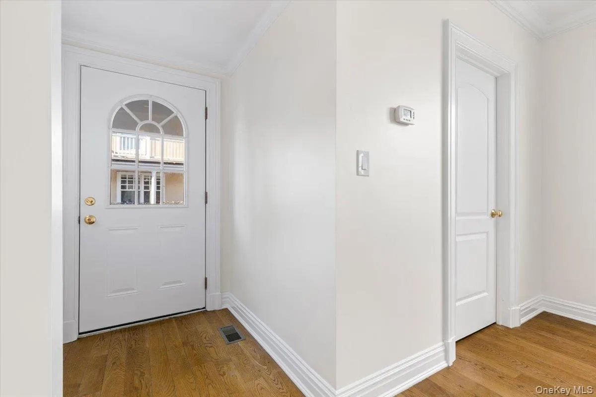 Back entrance to stone patio & 1 parking space - acts as a welcoming foyer entrance Back entrance to stone patio & 1 parking space - acts as a welcoming foyer entrance