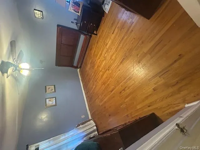 Bedroom featuring light wood finished floors and ceiling fan Bedroom featuring light wood finished floors and ceiling fan