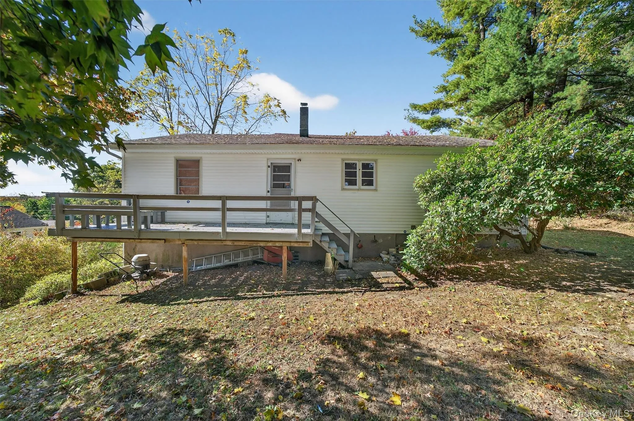 Back of property featuring a wooden deck Back of property featuring a wooden deck