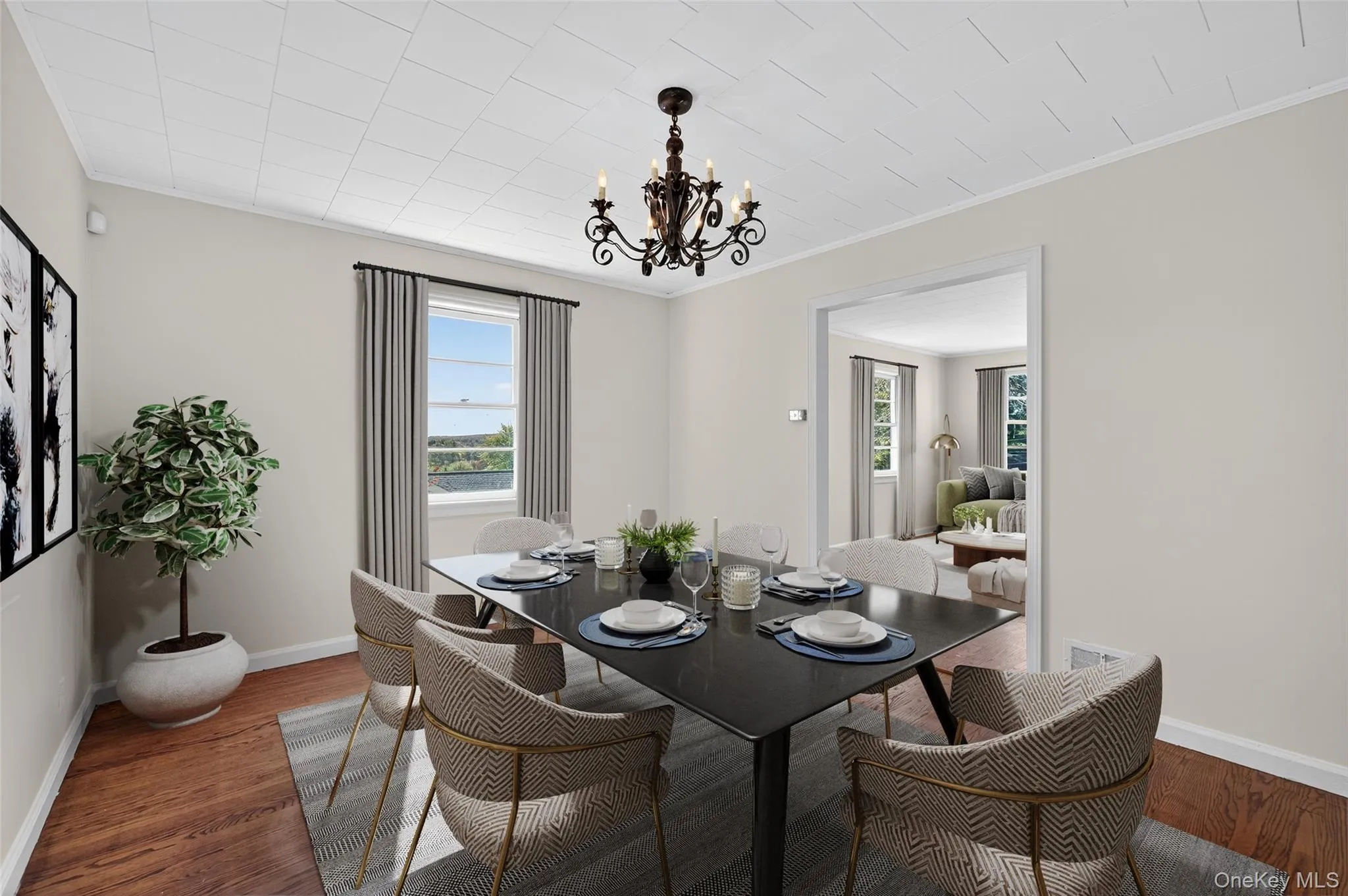 Dining area with a chandelier, ornamental molding, plenty of natural light, and wood finished floors Dining area with a chandelier, ornamental molding, plenty of natural light, and wood finished floors
