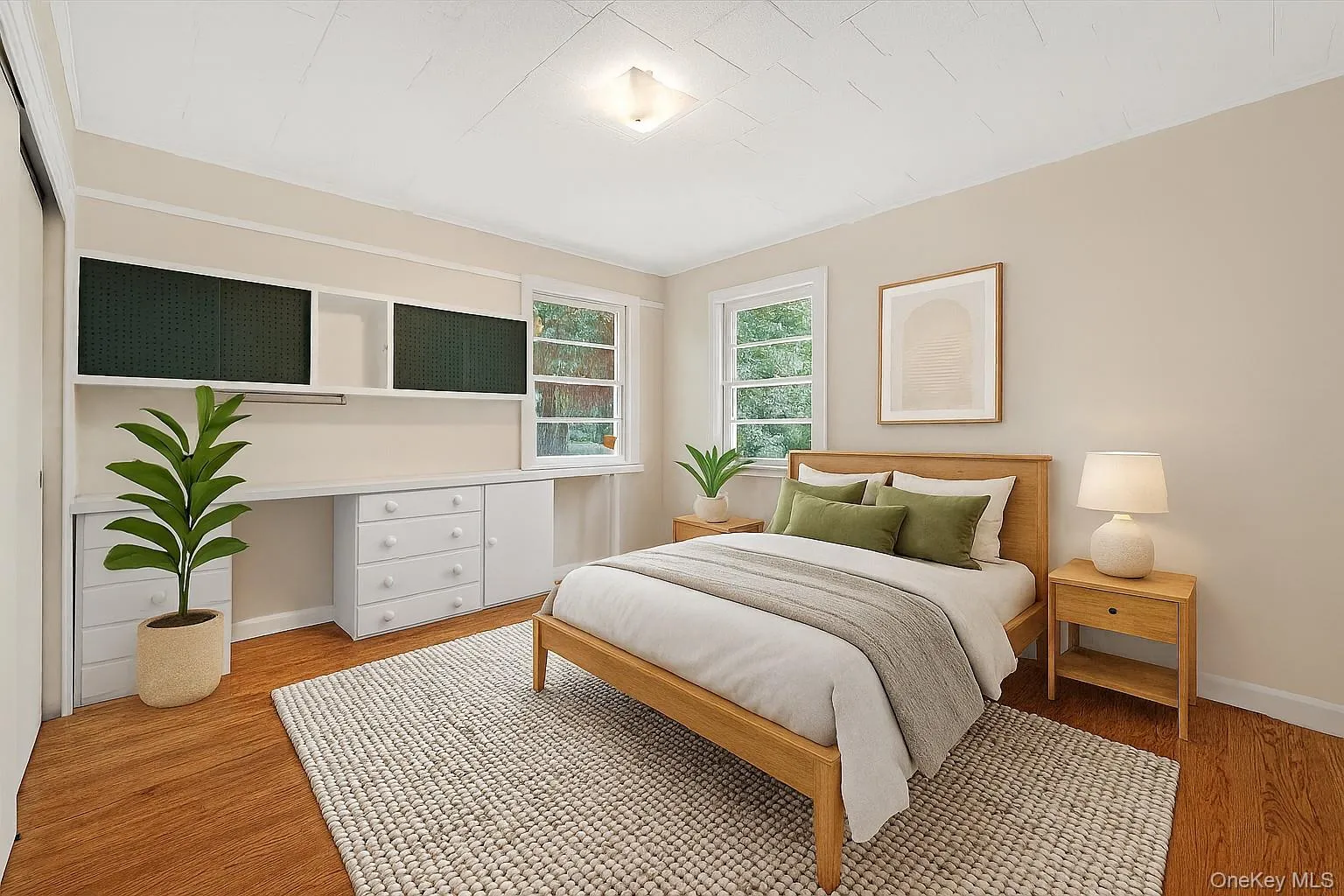 Bedroom with wood finished floors and built in desk Bedroom with wood finished floors and built in desk