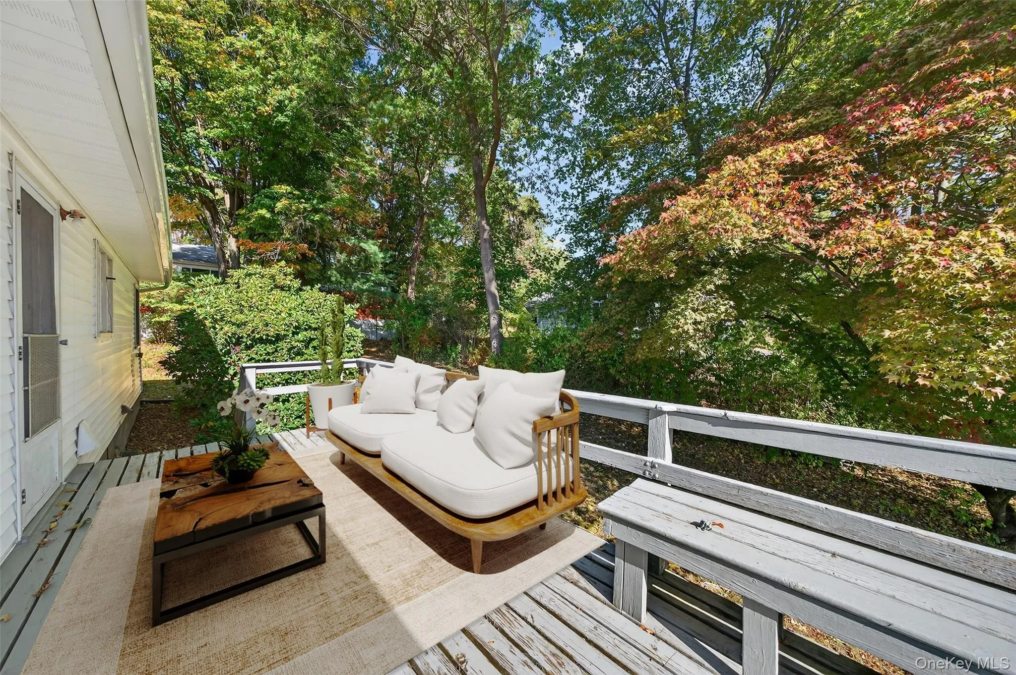 View of patio / terrace featuring an outdoor hangout area, a wooden deck, and view of scattered trees View of patio / terrace featuring an outdoor hangout area, a wooden deck, and view of scattered trees