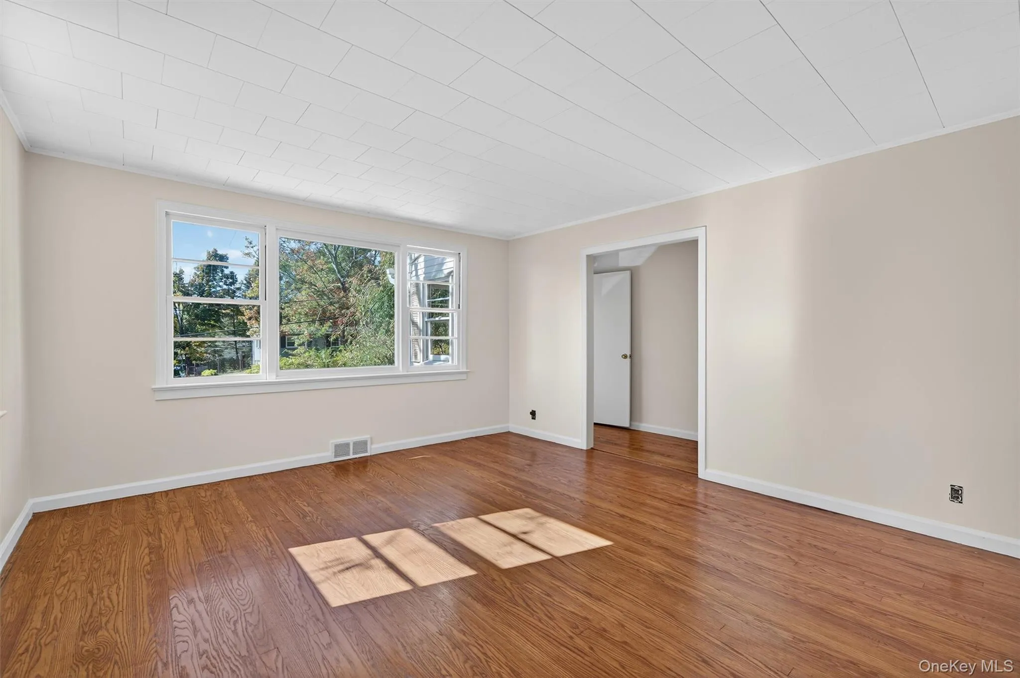 Empty room with wood finished floors and ornamental molding Empty room with wood finished floors and ornamental molding
