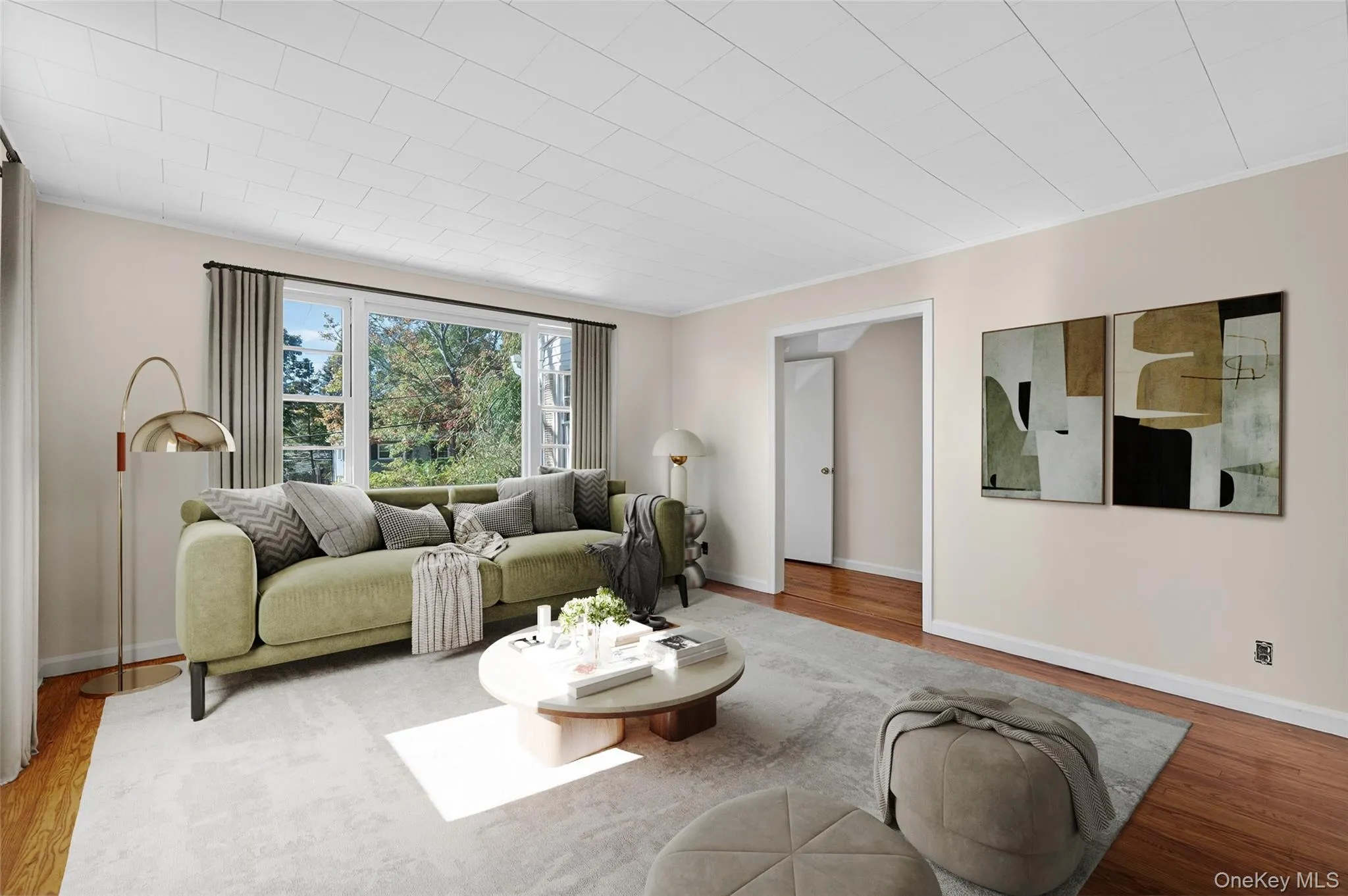 Living room with wood finished floors and crown molding Living room with wood finished floors and crown molding
