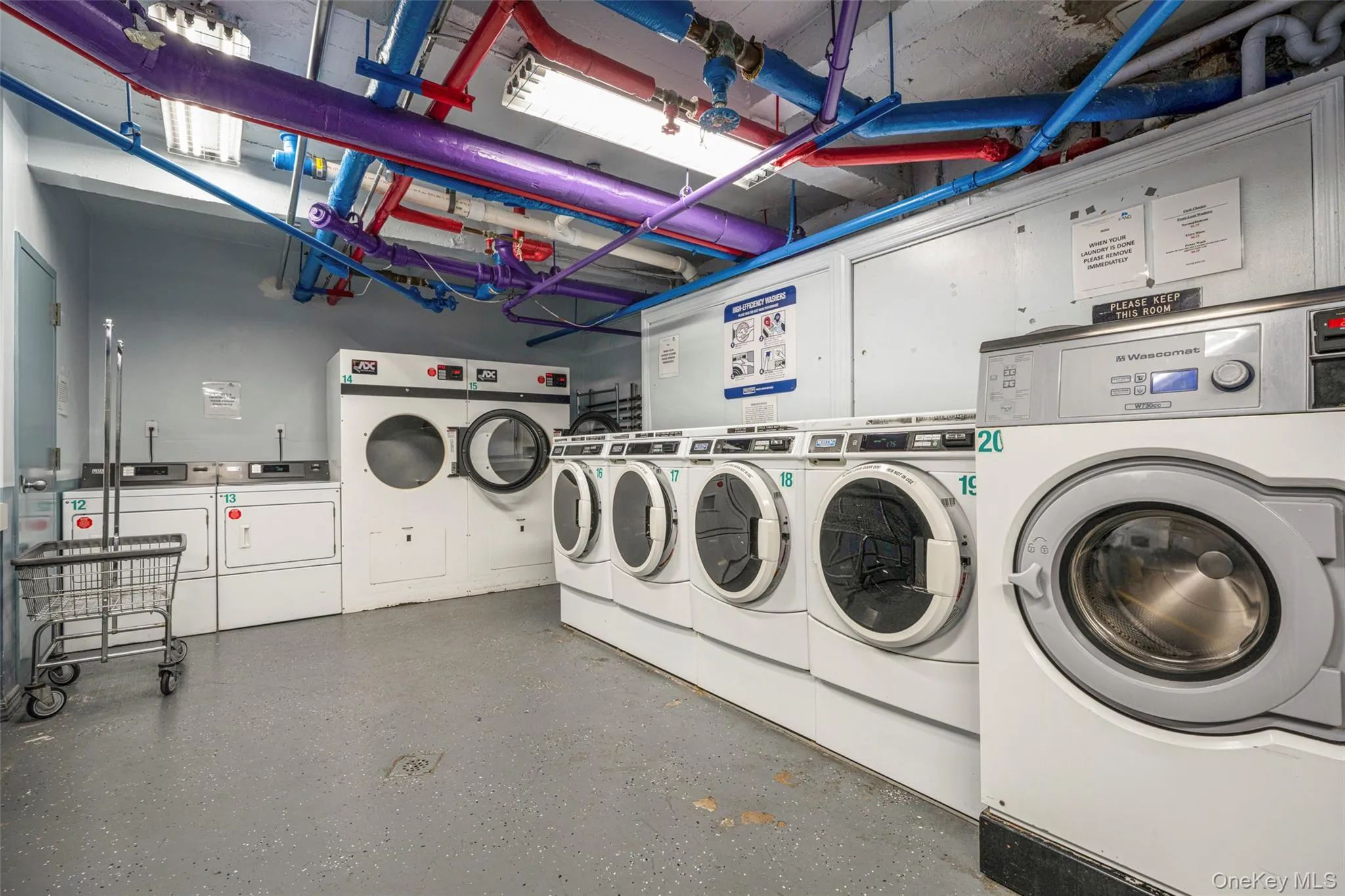 Communal laundry room with washing machine and dryer Communal laundry room with washing machine and dryer
