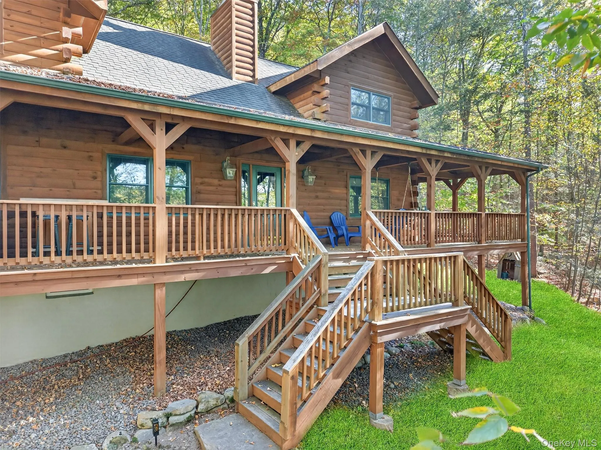 Wooden deck with covered porch, stairs, and a lawn Wooden deck with covered porch, stairs, and a lawn
