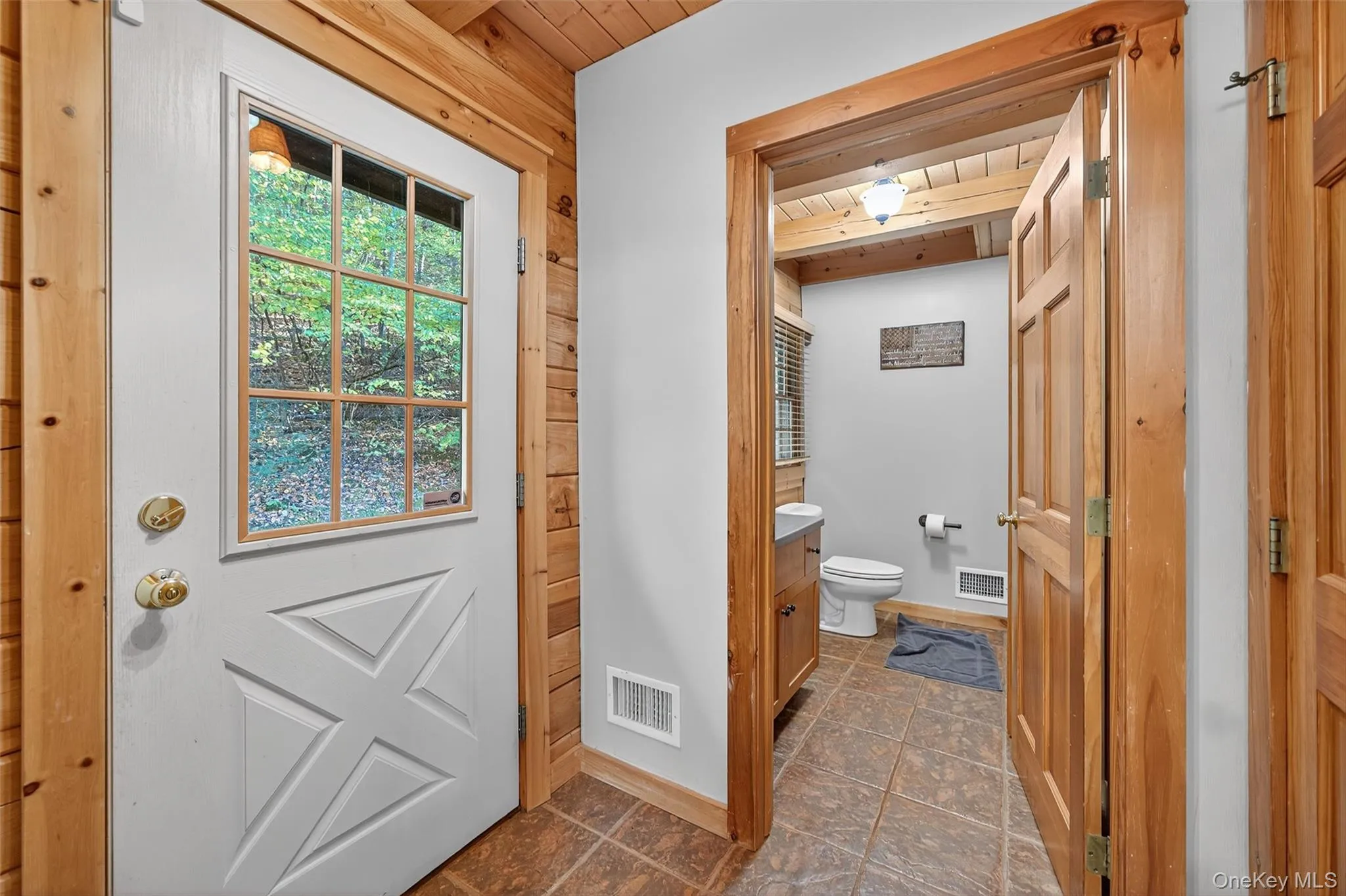 Half bathroom featuring vanity and a wood ceiling with exposed beams Half bathroom featuring vanity and a wood ceiling with exposed beams