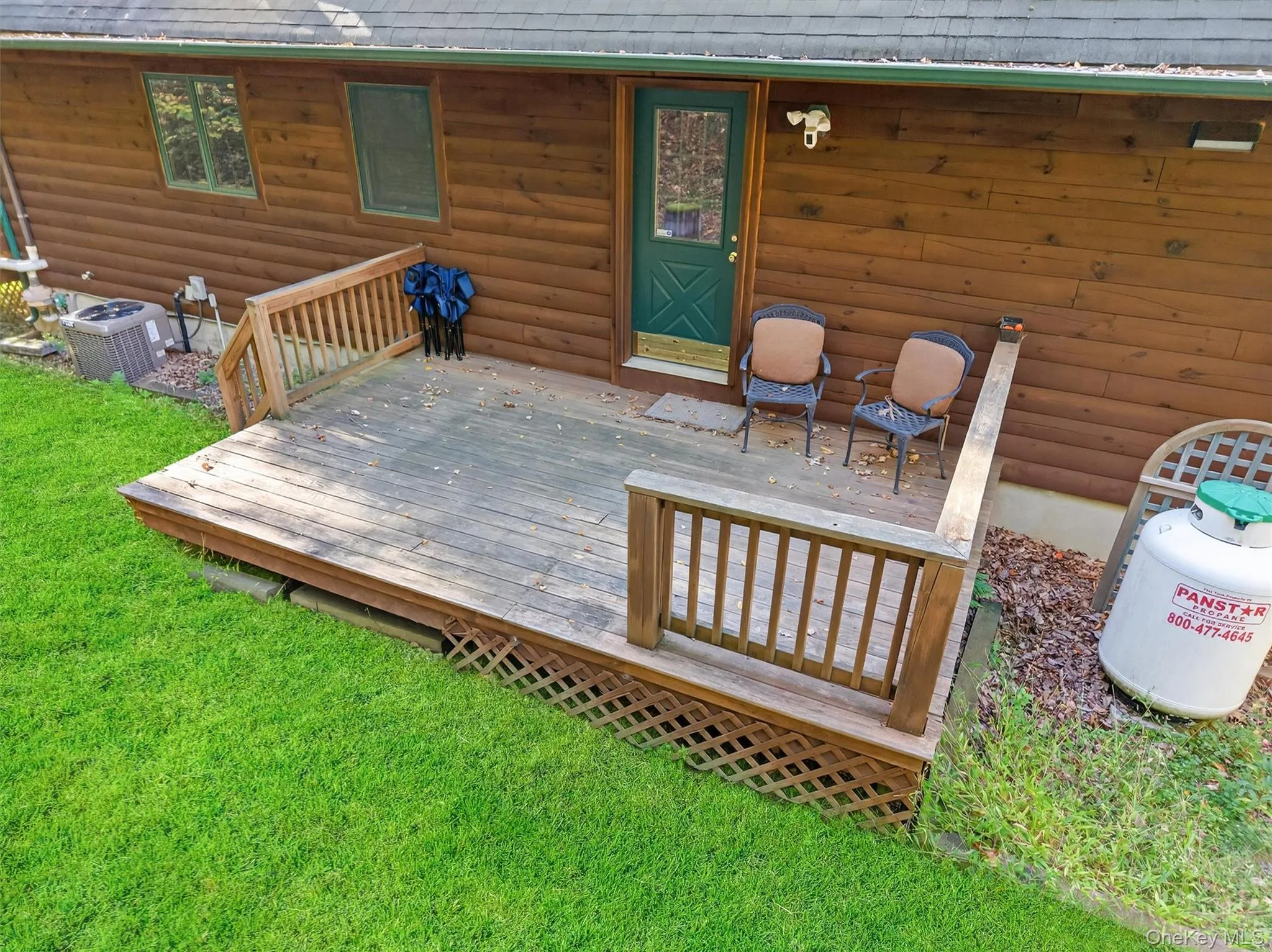 Wooden deck featuring a lawn Wooden deck featuring a lawn
