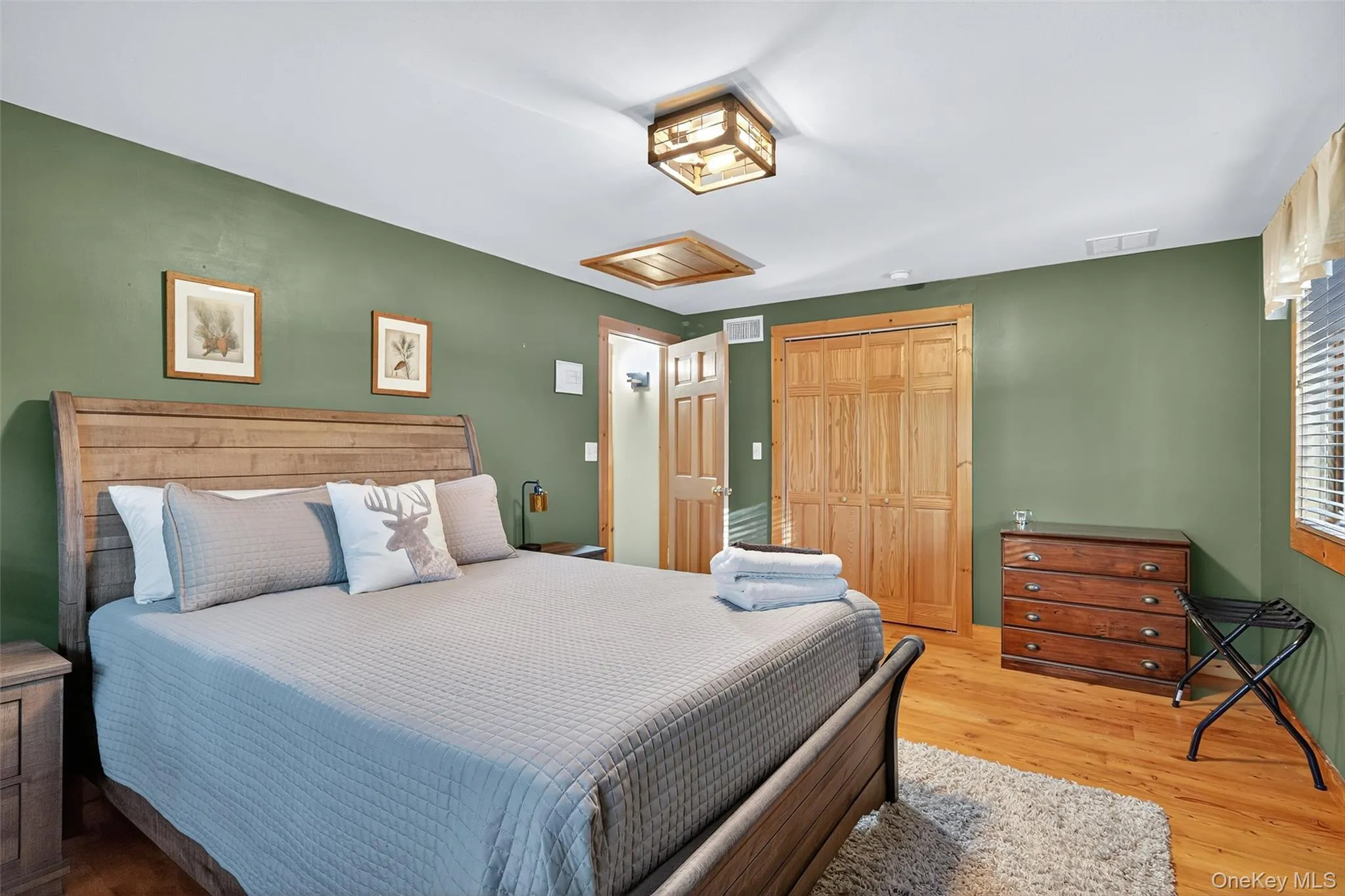 Bedroom featuring a closet and wood finished floors Bedroom featuring a closet and wood finished floors