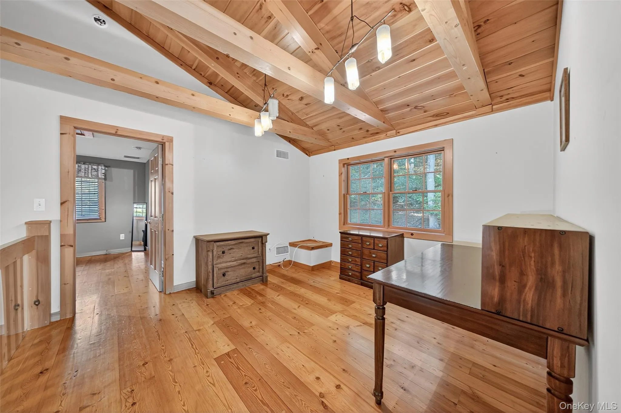 Office area featuring light wood-type flooring, plenty of natural light, and wood ceiling Office area featuring light wood-type flooring, plenty of natural light, and wood ceiling