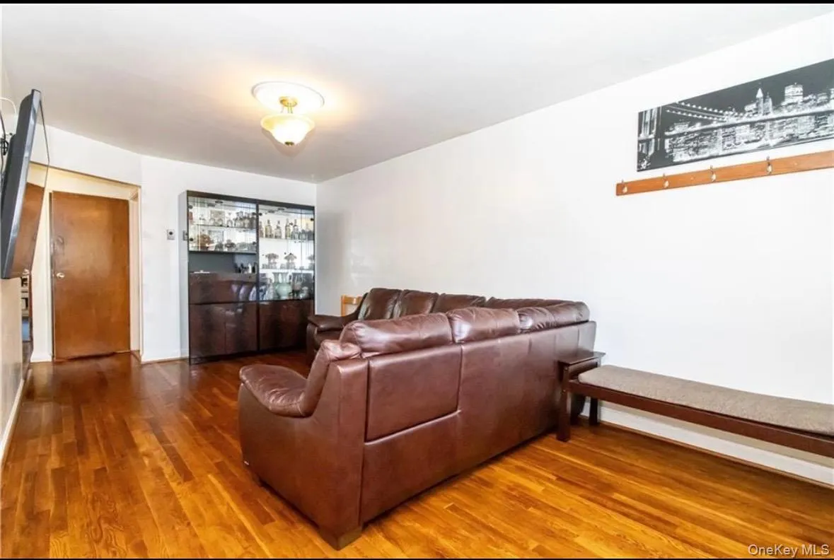 Living room featuring wood finished floors and baseboards Living room featuring wood finished floors and baseboards