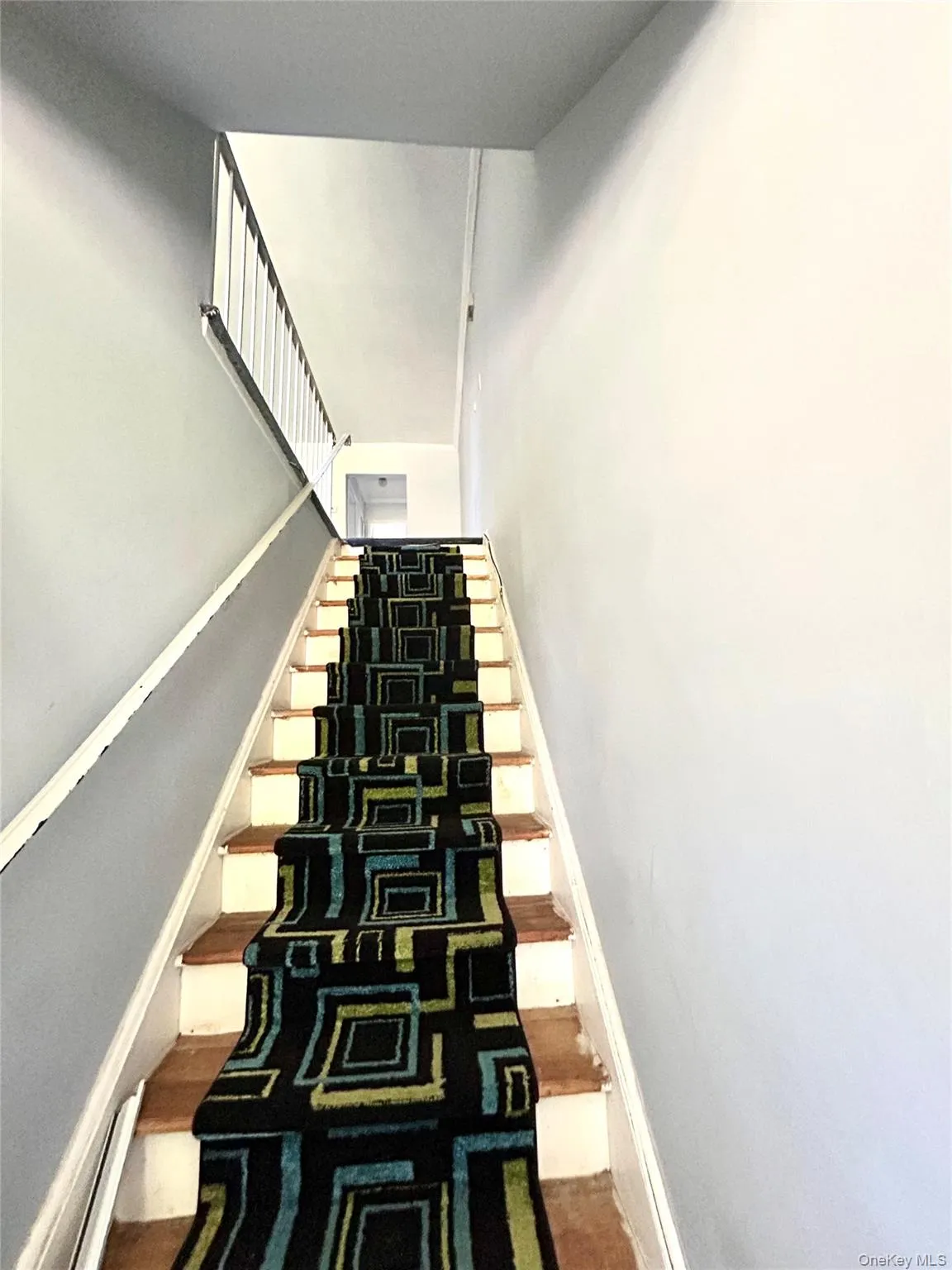 Staircase featuring a baseboard radiator Staircase featuring a baseboard radiator