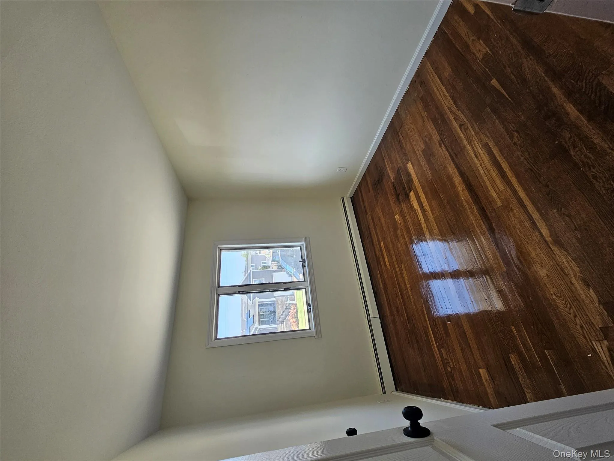 Spare room with dark wood-style floors and a baseboard radiator Spare room with dark wood-style floors and a baseboard radiator