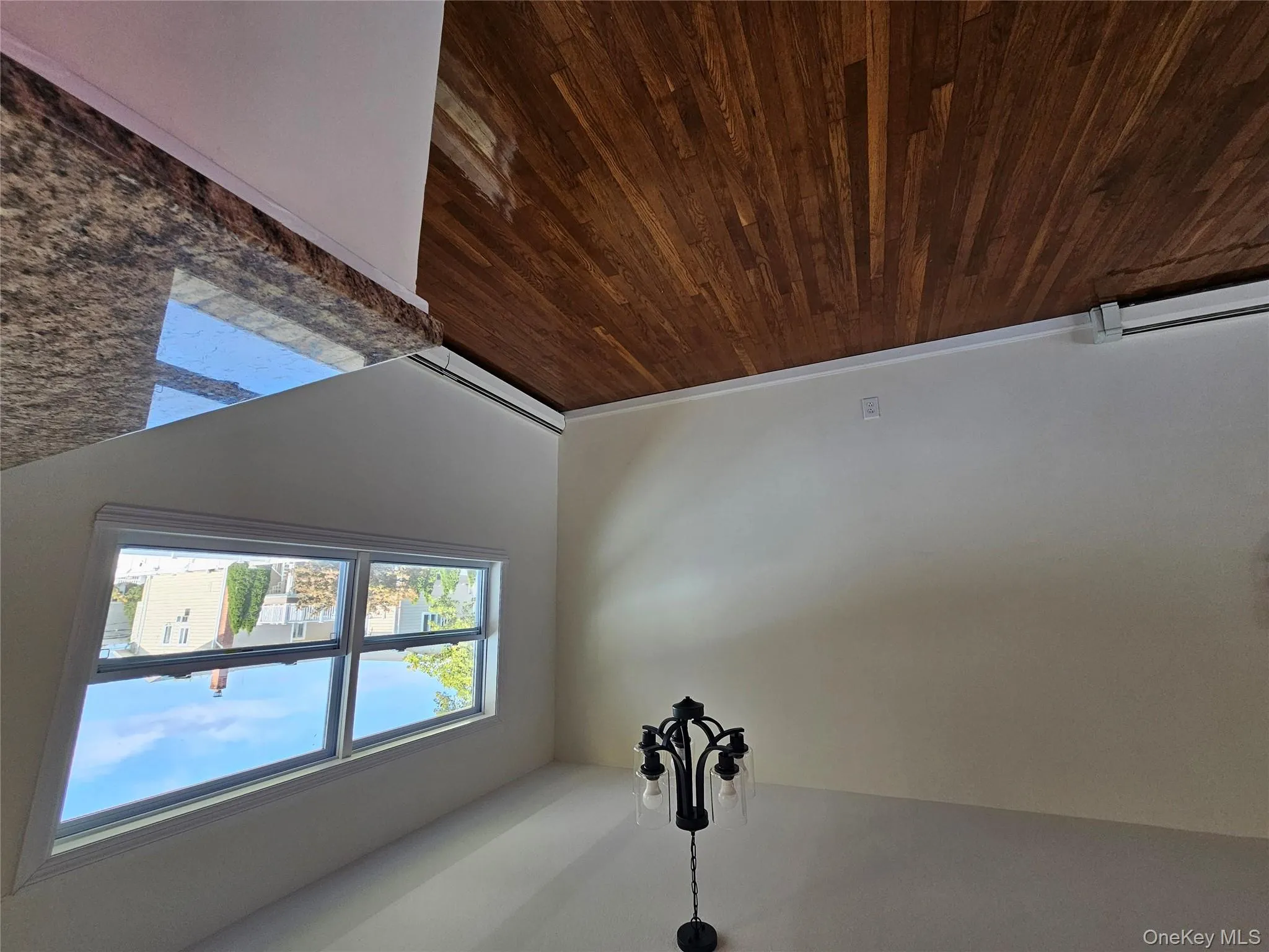 Unfurnished dining area with dark wood finished floors, a chandelier, and a baseboard heating unit Unfurnished dining area with dark wood finished floors, a chandelier, and a baseboard heating unit