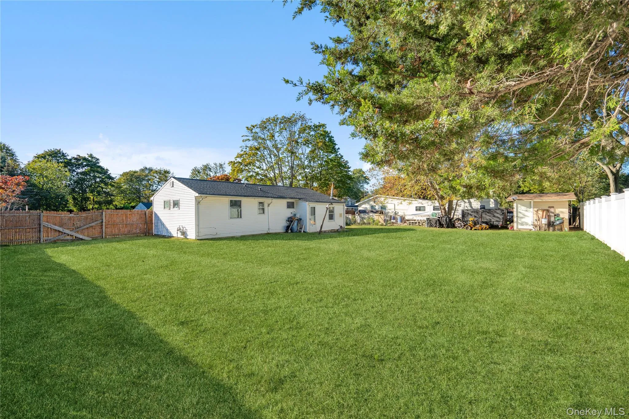 Fenced backyard with a storage unit Fenced backyard with a storage unit