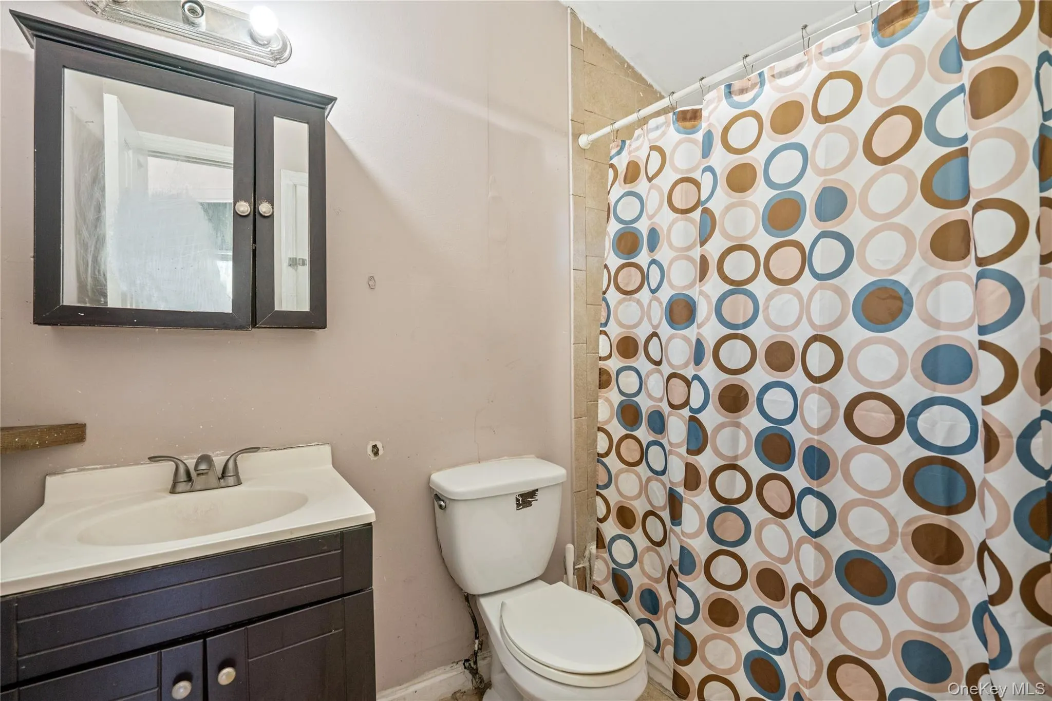 Full bath featuring vanity and a shower with shower curtain Full bath featuring vanity and a shower with shower curtain