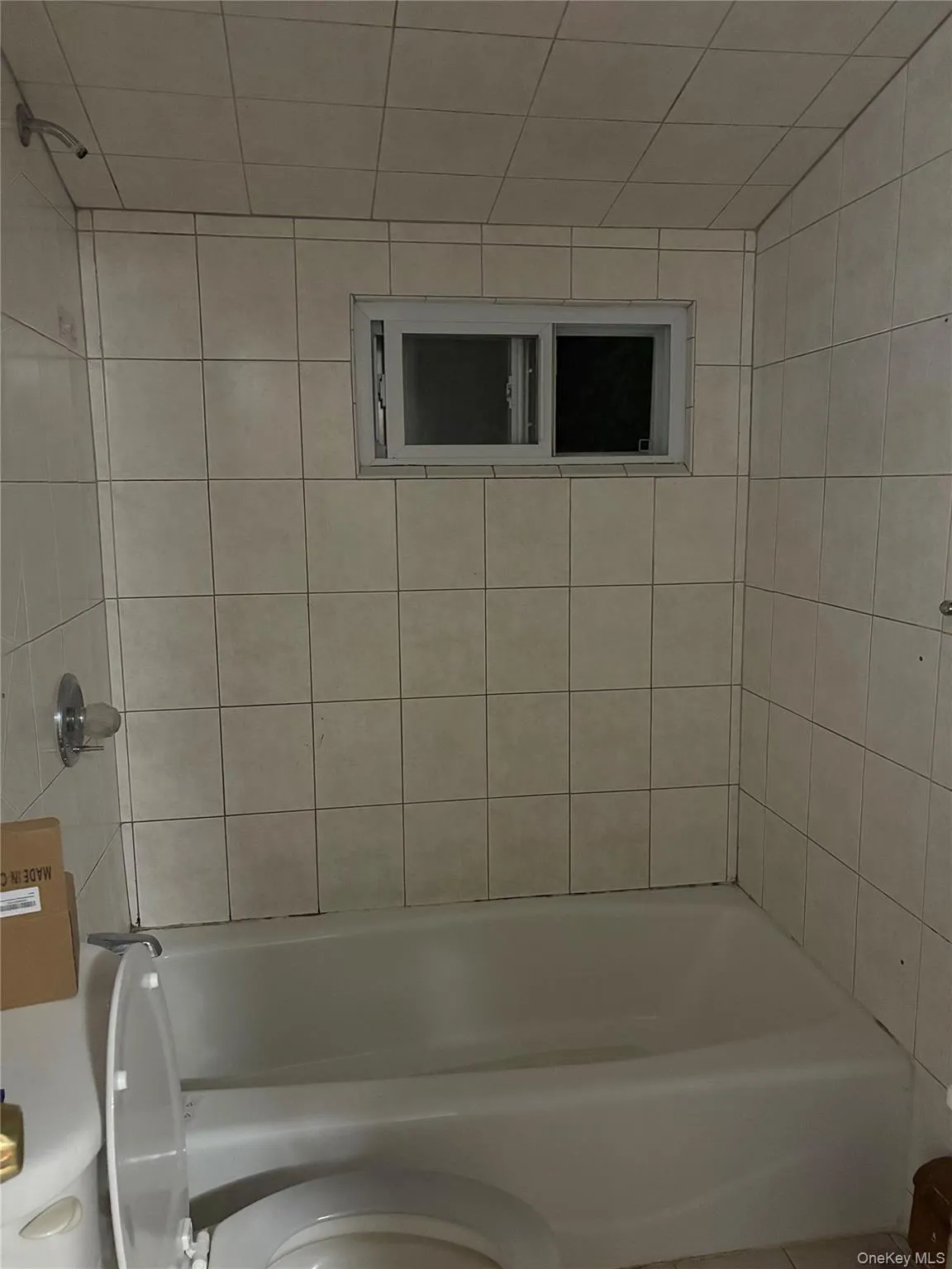 Bathroom with shower / bath combination and tile patterned flooring Bathroom with shower / bath combination and tile patterned flooring