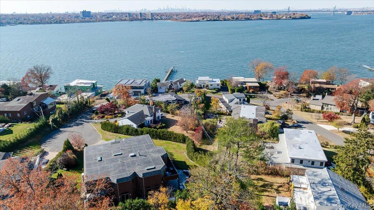 Aerial perspective of suburban area featuring a nearby body of water Aerial perspective of suburban area featuring a nearby body of water