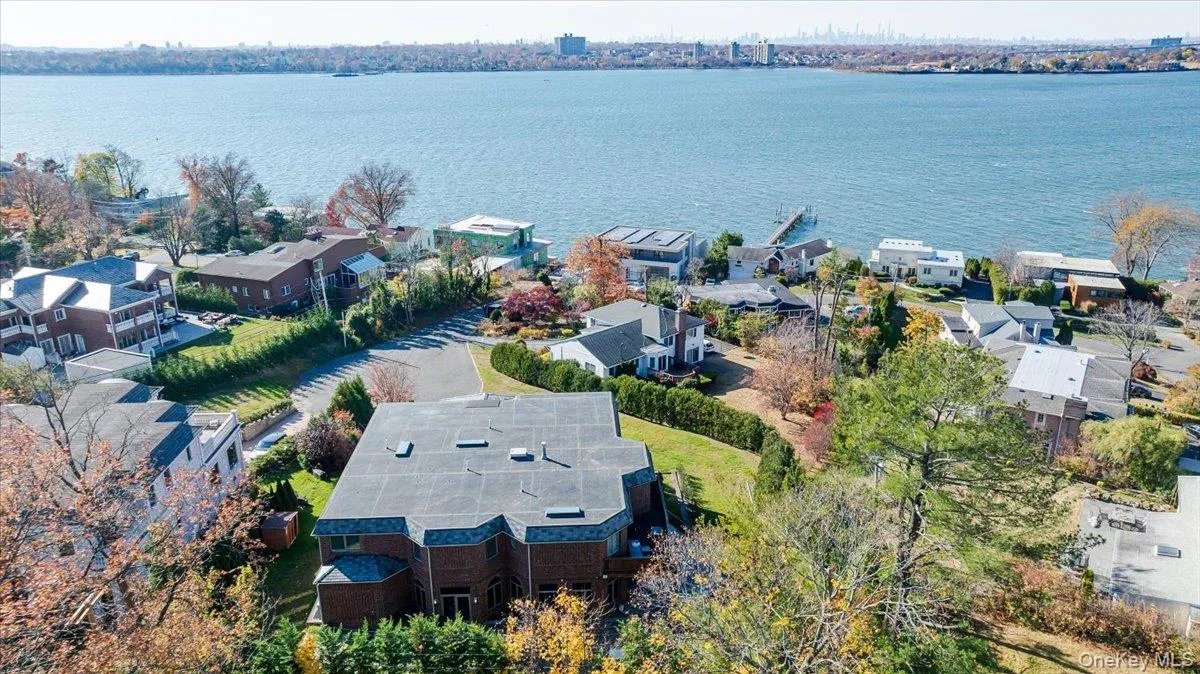 Aerial perspective of suburban area featuring a large body of water Aerial perspective of suburban area featuring a large body of water