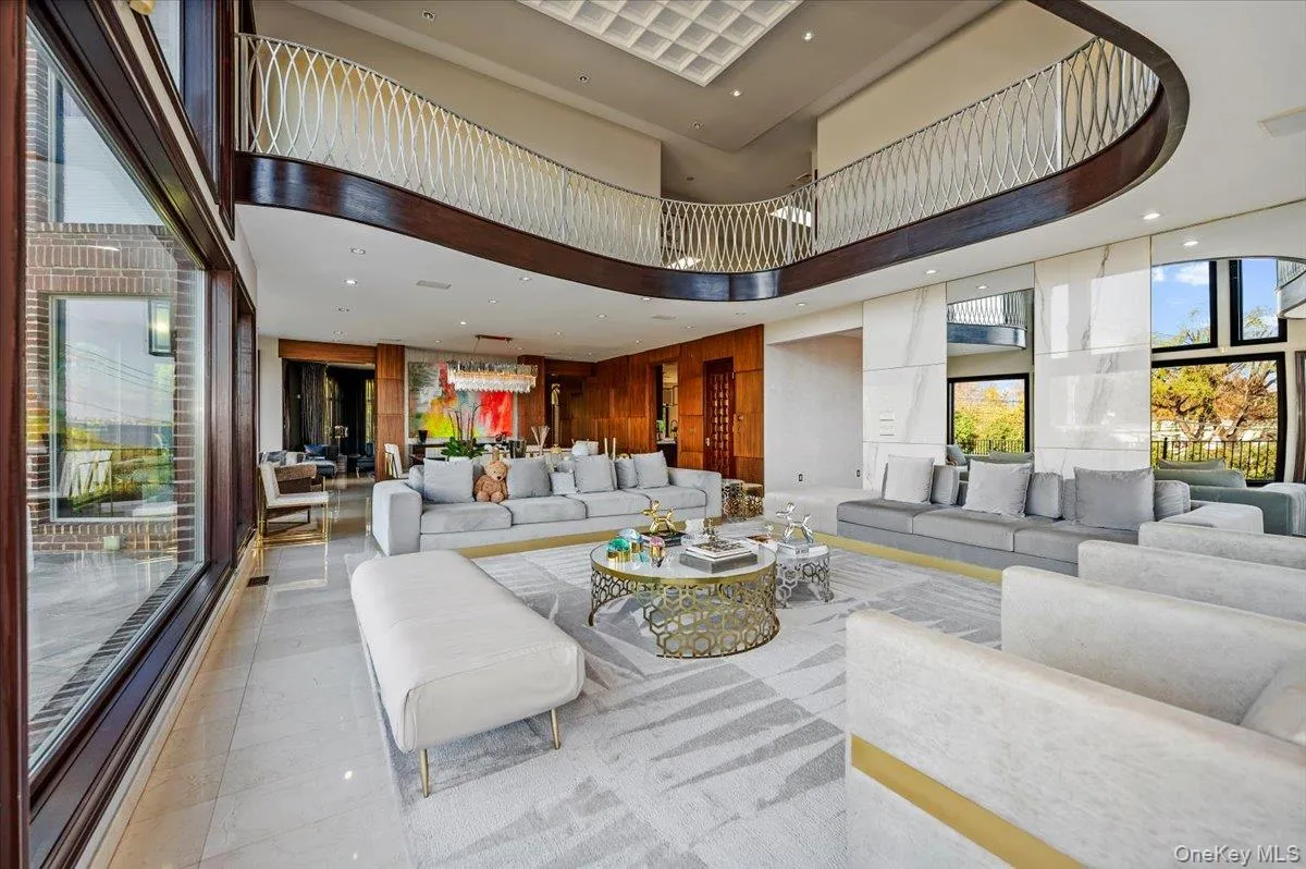 Common area with recessed lighting, a towering ceiling, and wood walls Common area with recessed lighting, a towering ceiling, and wood walls