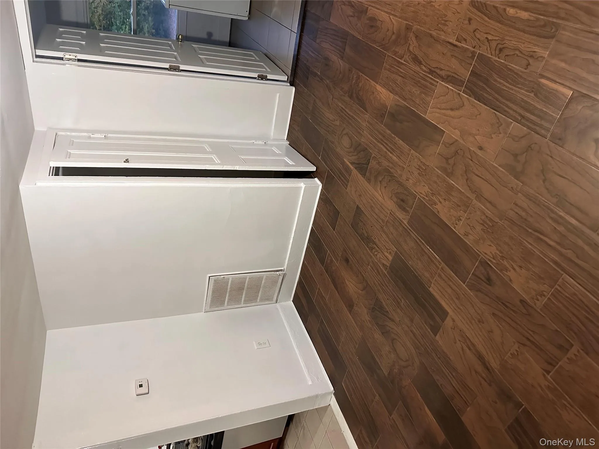 Unfurnished room featuring dark wood-style floors Unfurnished room featuring dark wood-style floors