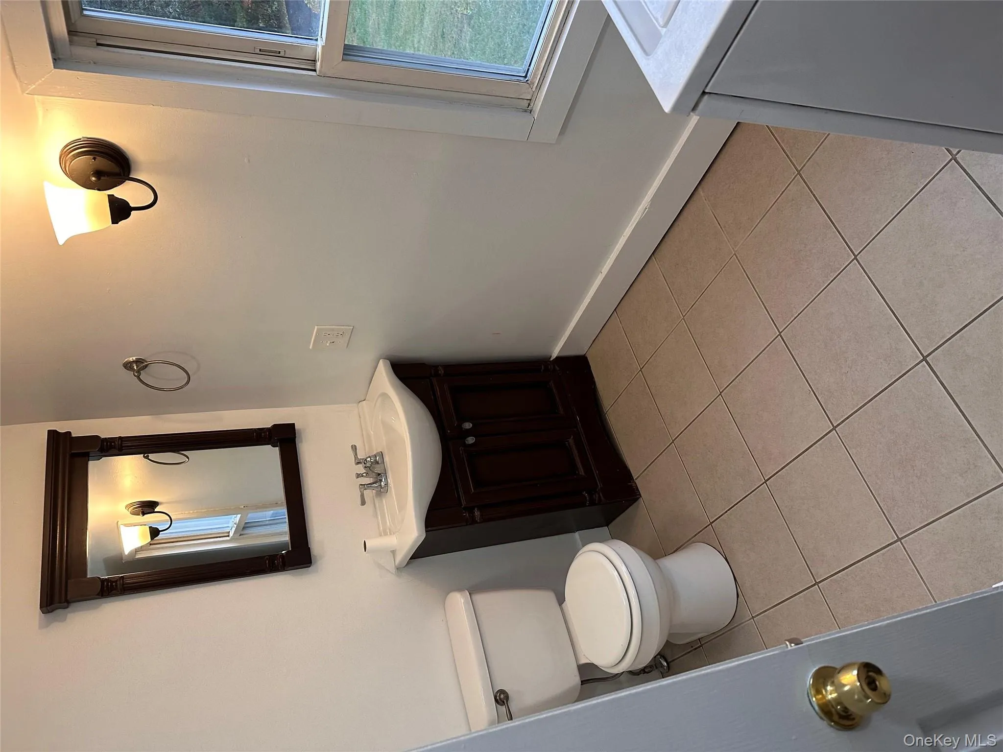 Bathroom featuring light tile patterned flooring, vanity, and washer / clothes dryer Bathroom featuring light tile patterned flooring, vanity, and washer / clothes dryer
