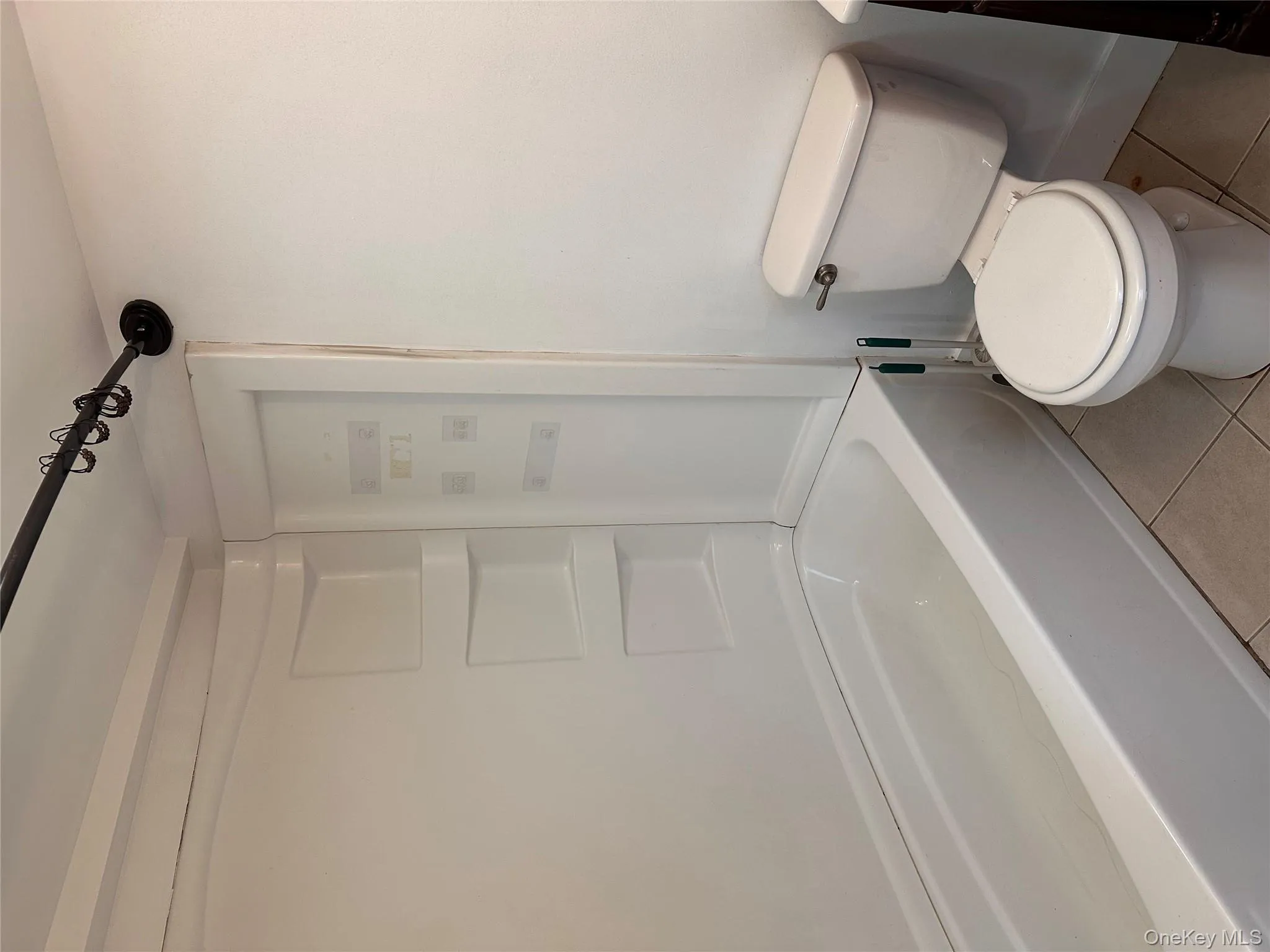 Bathroom with light tile patterned floors and  shower combination Bathroom with light tile patterned floors and  shower combination