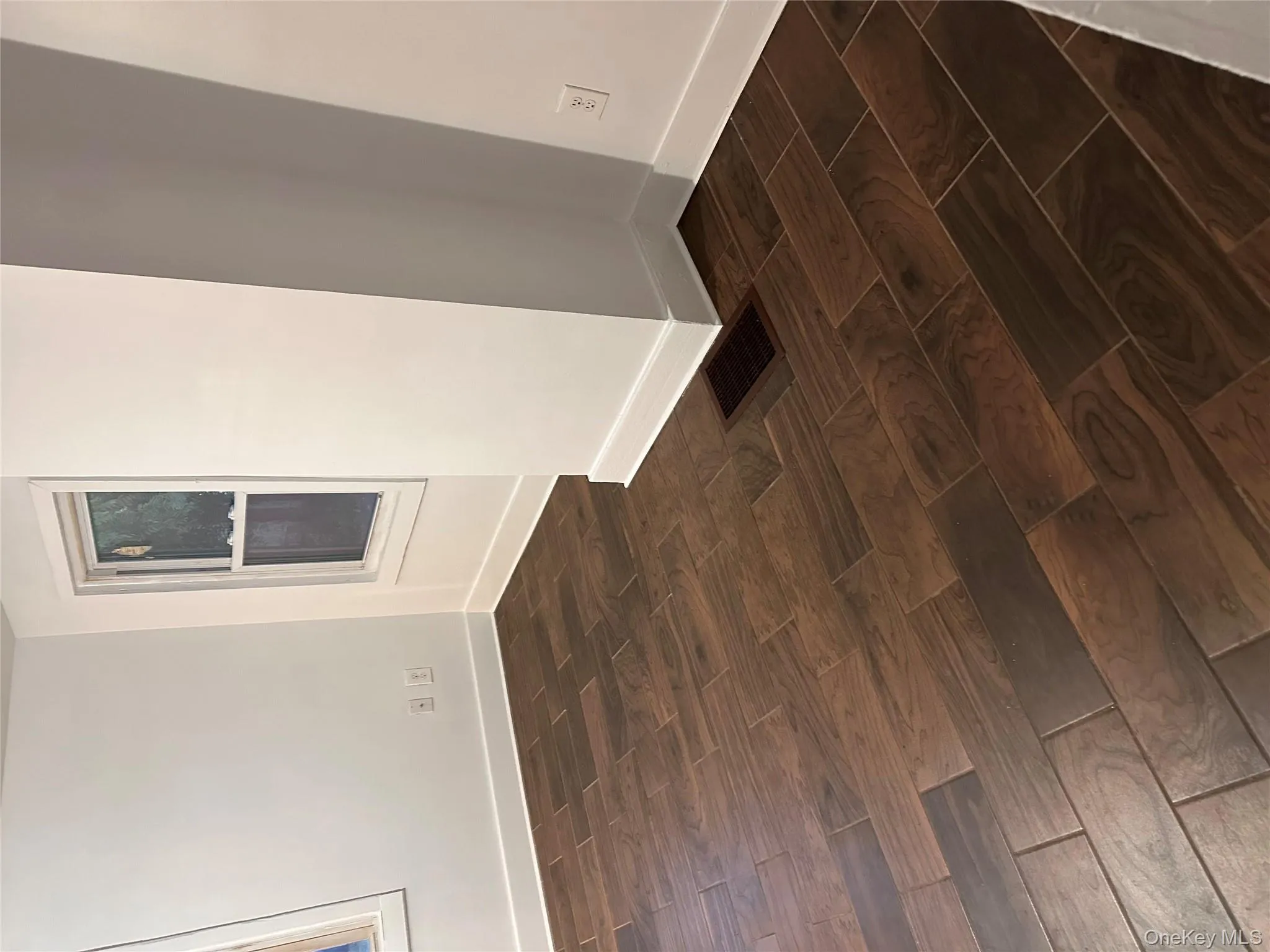 Unfurnished room with wood tiled floors and baseboards Unfurnished room with wood tiled floors and baseboards