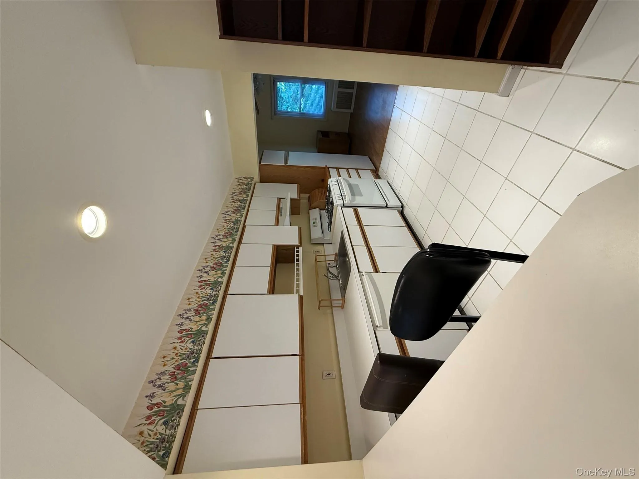 Kitchen with white cabinetry, light countertops, range, recessed lighting, and light tile patterned flooring Kitchen with white cabinetry, light countertops, range, recessed lighting, and light tile patterned flooring