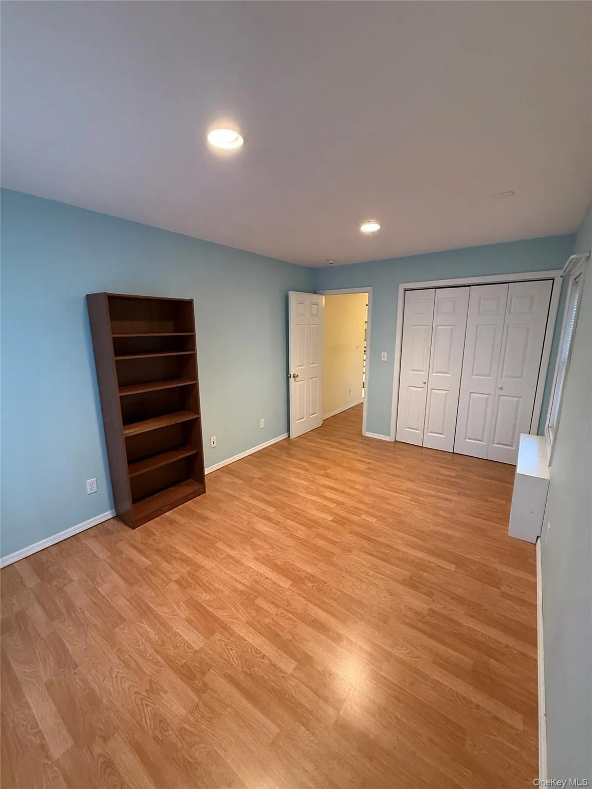 Unfurnished bedroom with light wood-style floors, recessed lighting, and a closet Unfurnished bedroom with light wood-style floors, recessed lighting, and a closet
