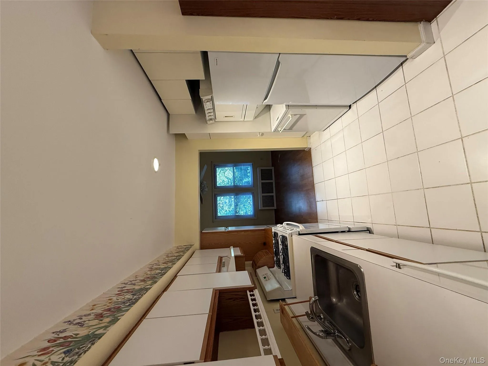 Kitchen featuring white cabinetry, stove, fridge, light countertops, and recessed lighting Kitchen featuring white cabinetry, stove, fridge, light countertops, and recessed lighting